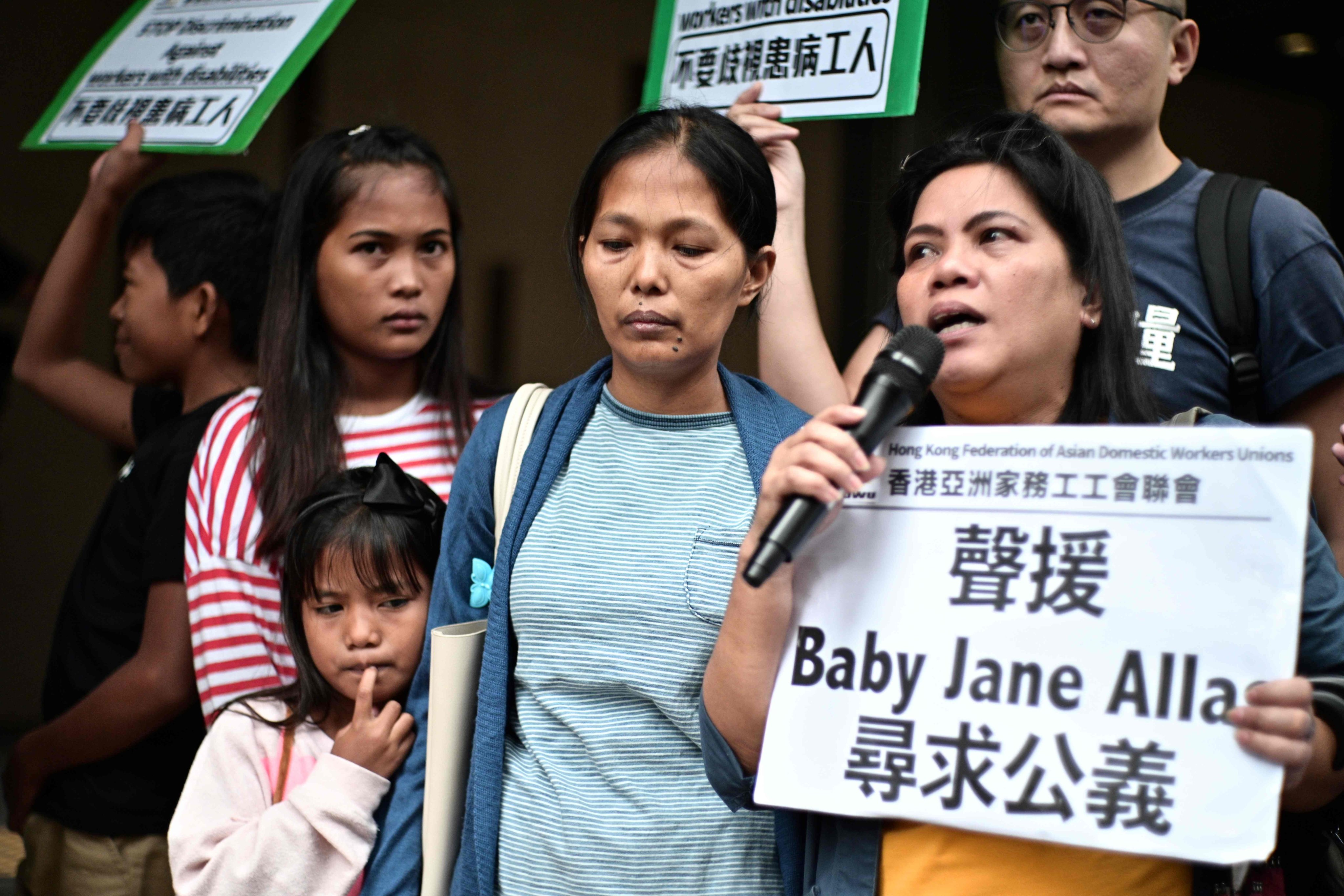 Allas (centre) appears at a rally. Photo: AFP