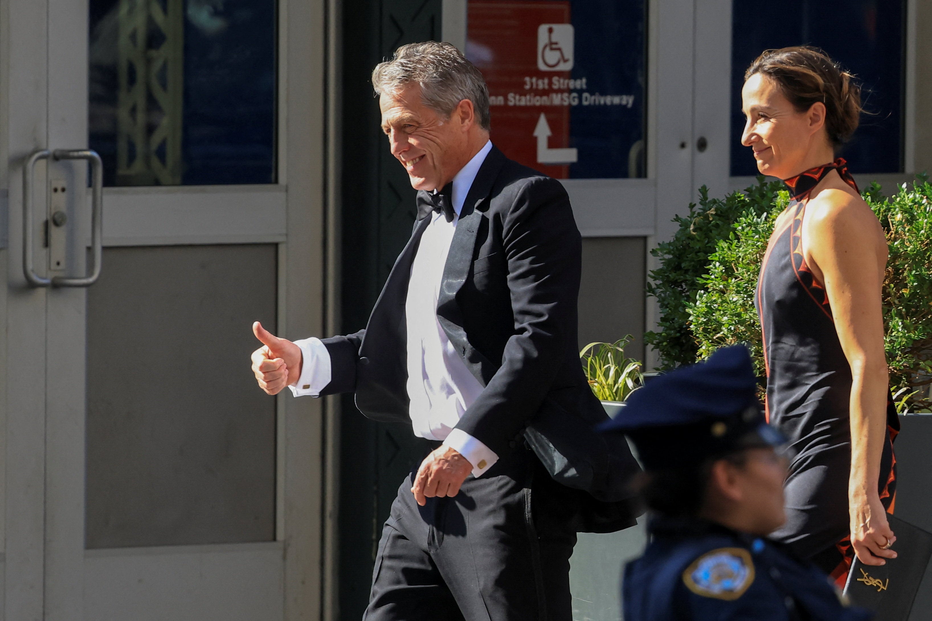 Actor Hugh Grant and his wife Anna Eberstein arrive at Madison Square Garden on Friday. Photo: Reuters