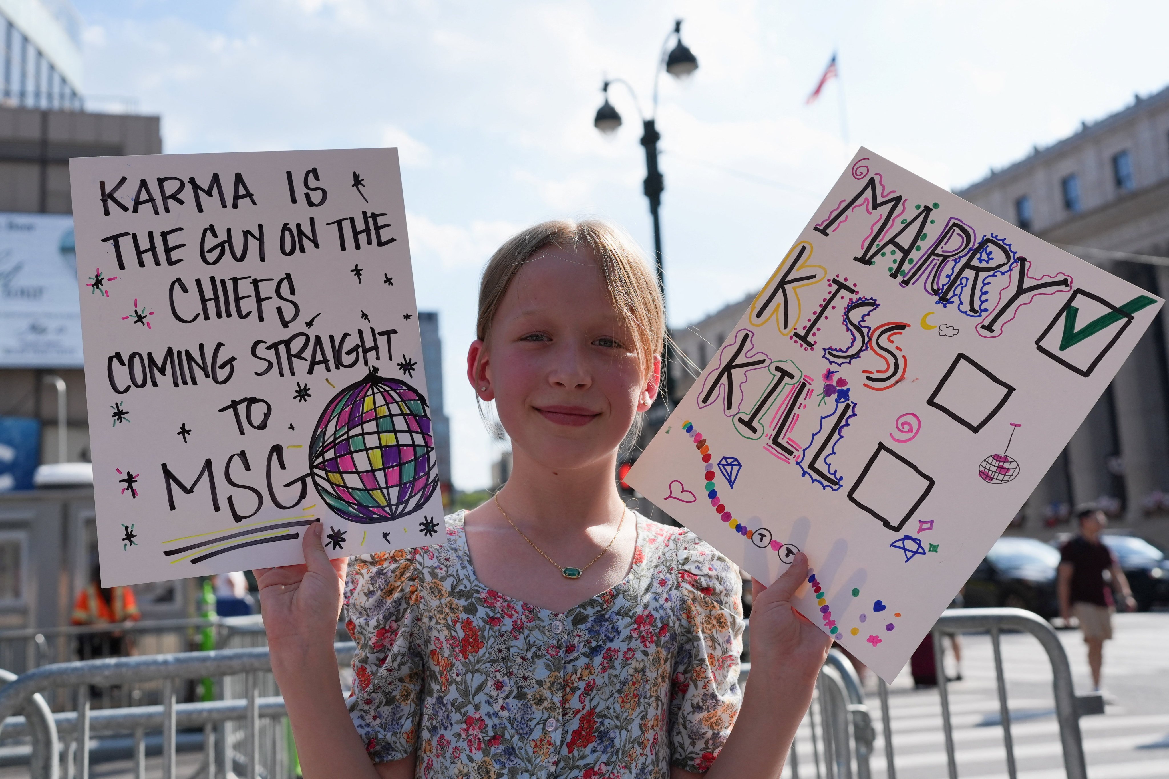 A child holds placards near Madison Square Garden on Friday. Photo: Reuters