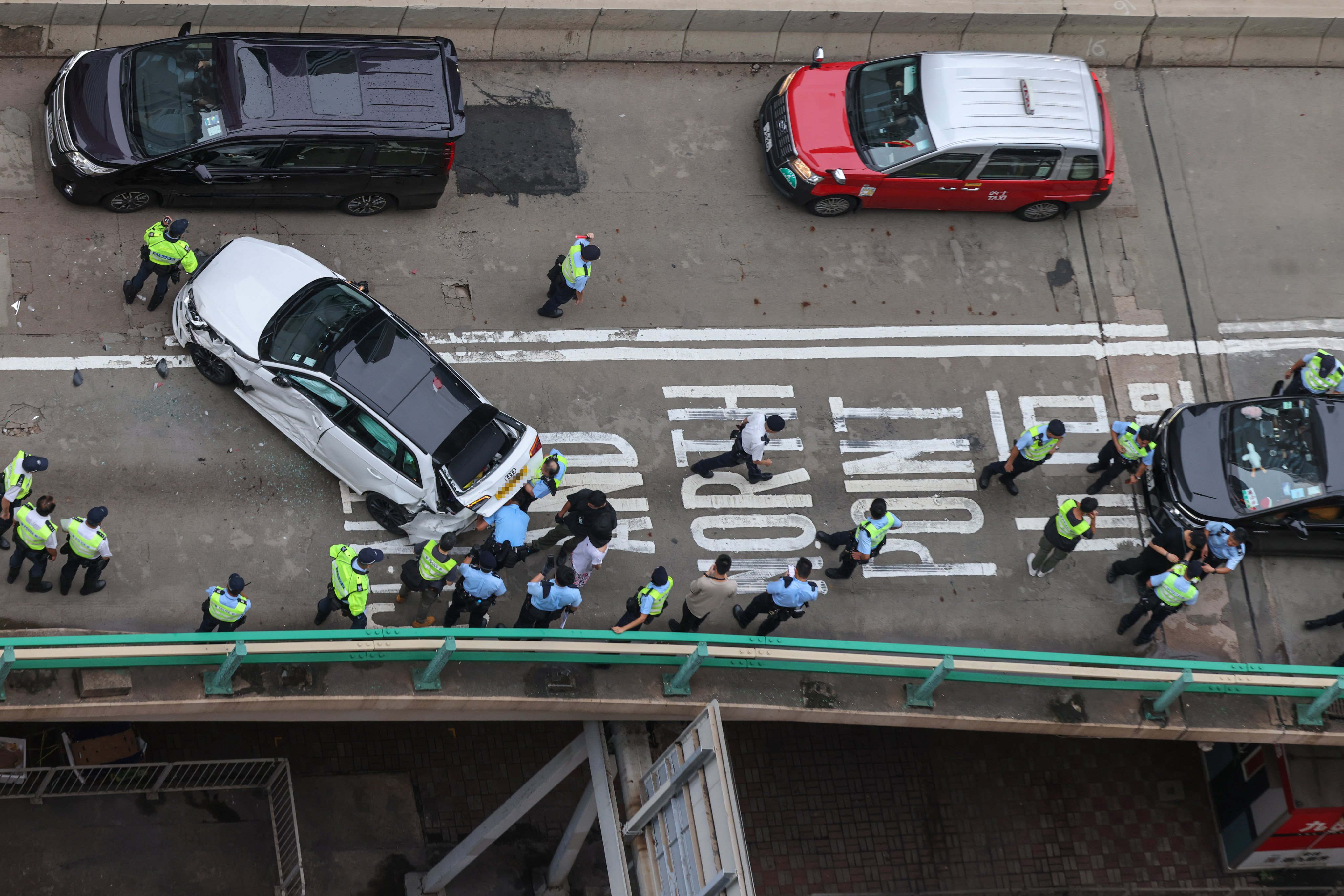 Police detain a suspect on the Canal Road Flyover after a high-speed chase ended in a multi-vehicle crash. Photo: Nora Tam