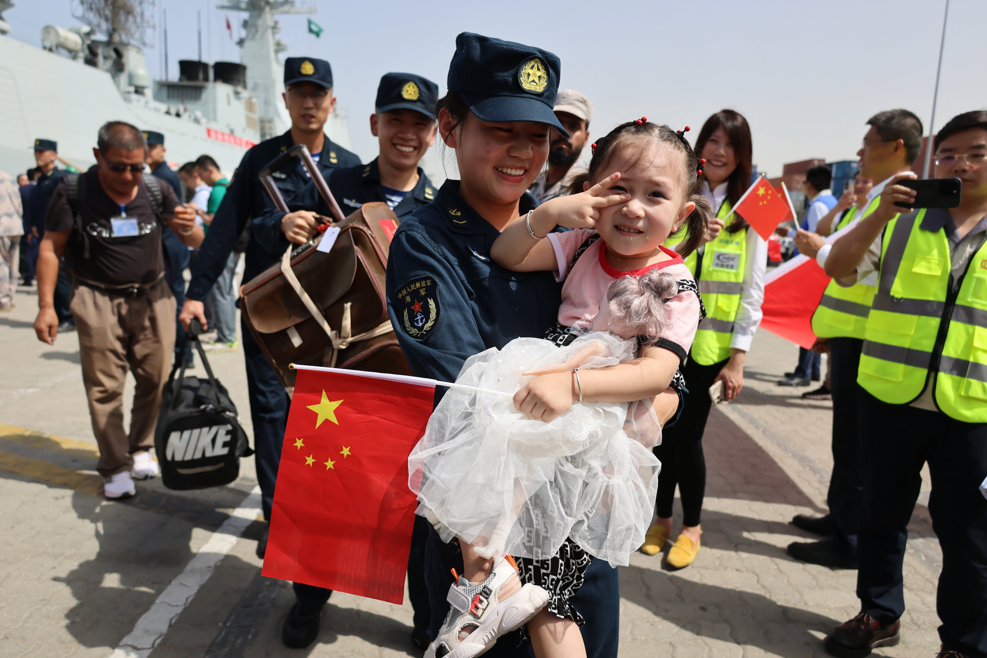A PLA member helps escort a child at the Saudi Arabian port of Jeddah in April 2023. Photo: Xinhua