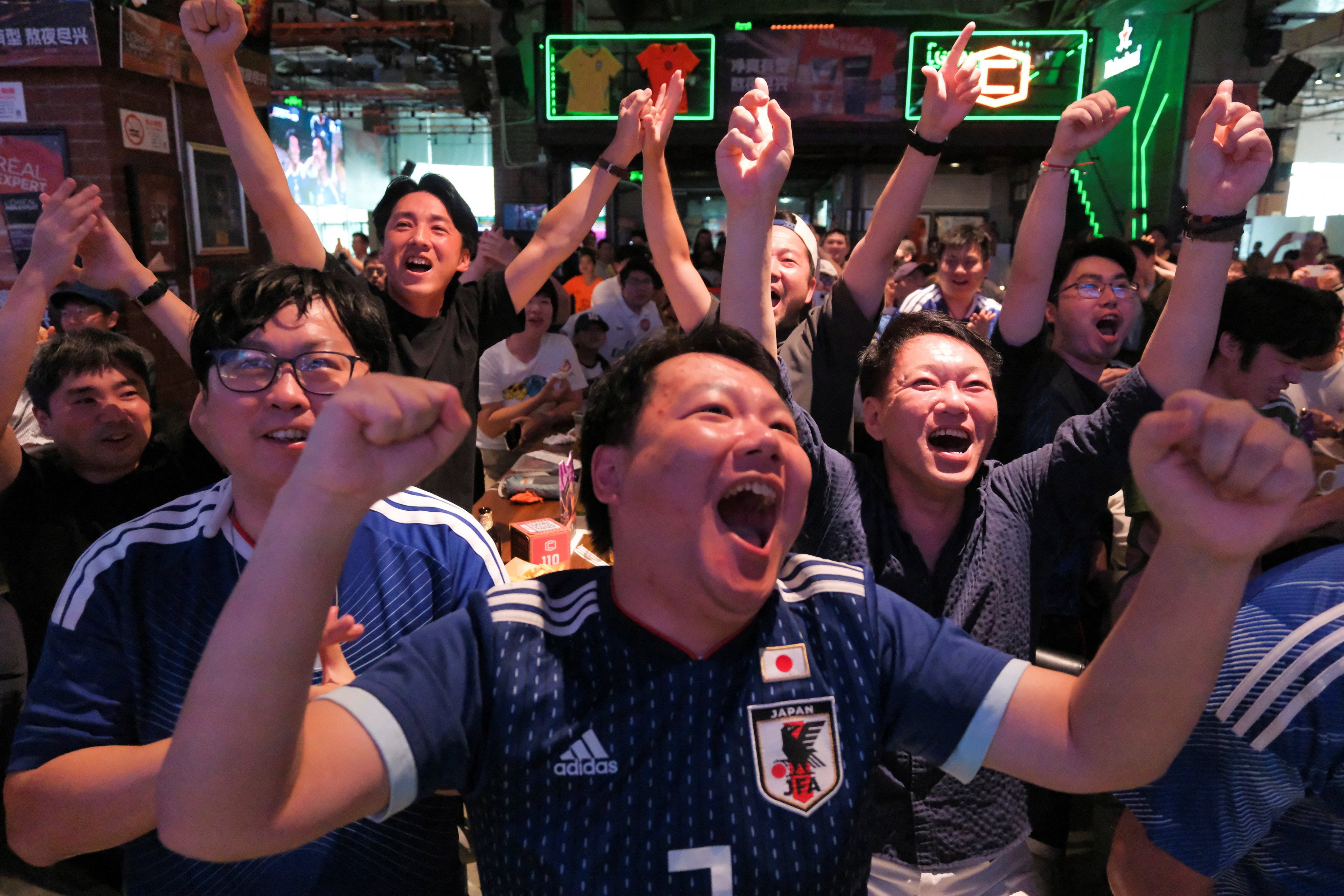 Fans in Shanghai cheer during a Fifa World Cup match between Japan and Tunisia on June 21. Japan won 4-0 but were later knocked out of the tournament. Photo: Reuters