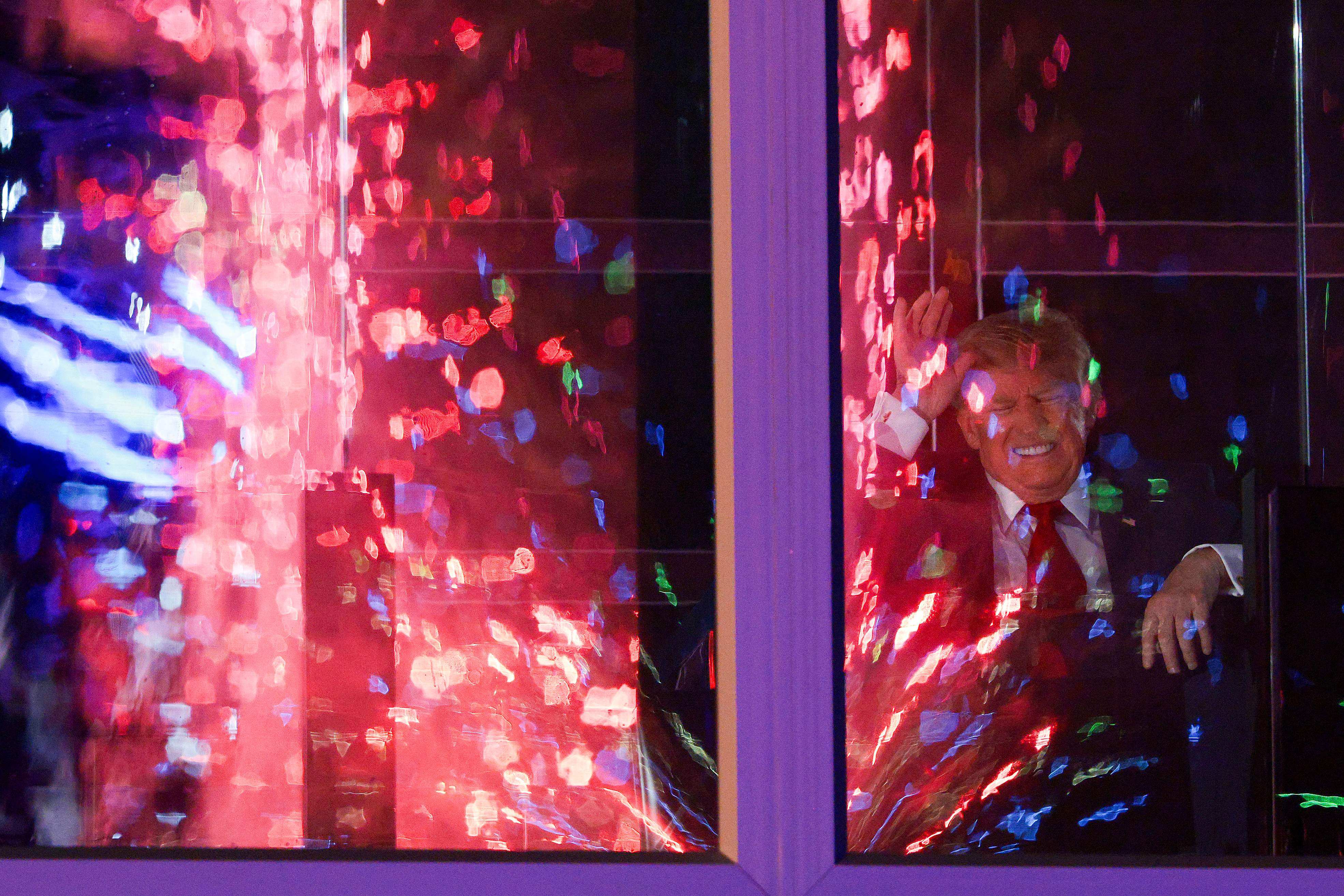 US President Donald Trump watches fireworks from inside a building during the “Salute to America” celebration in Washington on Saturday. Photo: AFP
