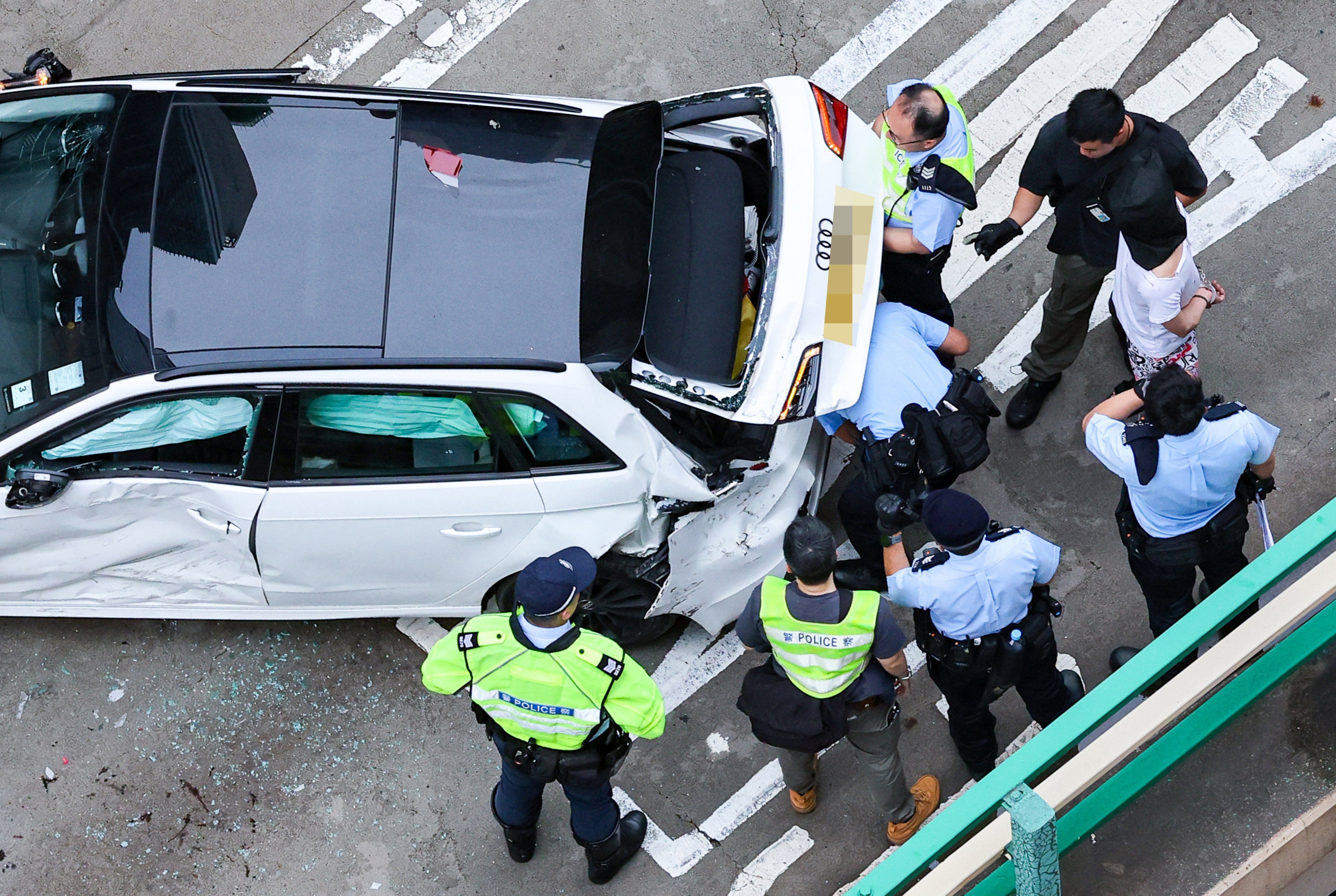 Police detain a suspect on the Canal Road Flyover after a high-speed chase ended in a multi-vehicle crash. Photo: Nora Tam