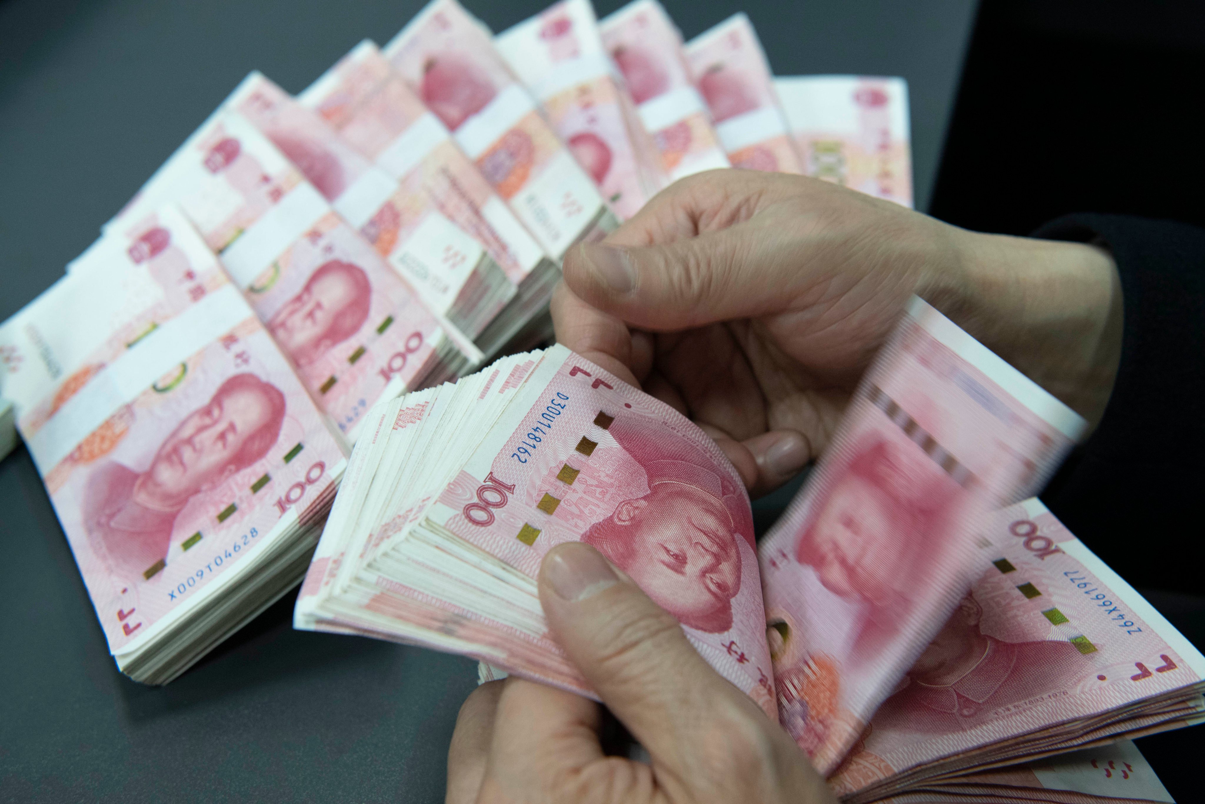 An employee at  Construction Bank counts Chinese yuan notes in Hai’an City, Jiangsu province, January 20, 2026. Photo: CFOTO/Future Publishing via Getty Images