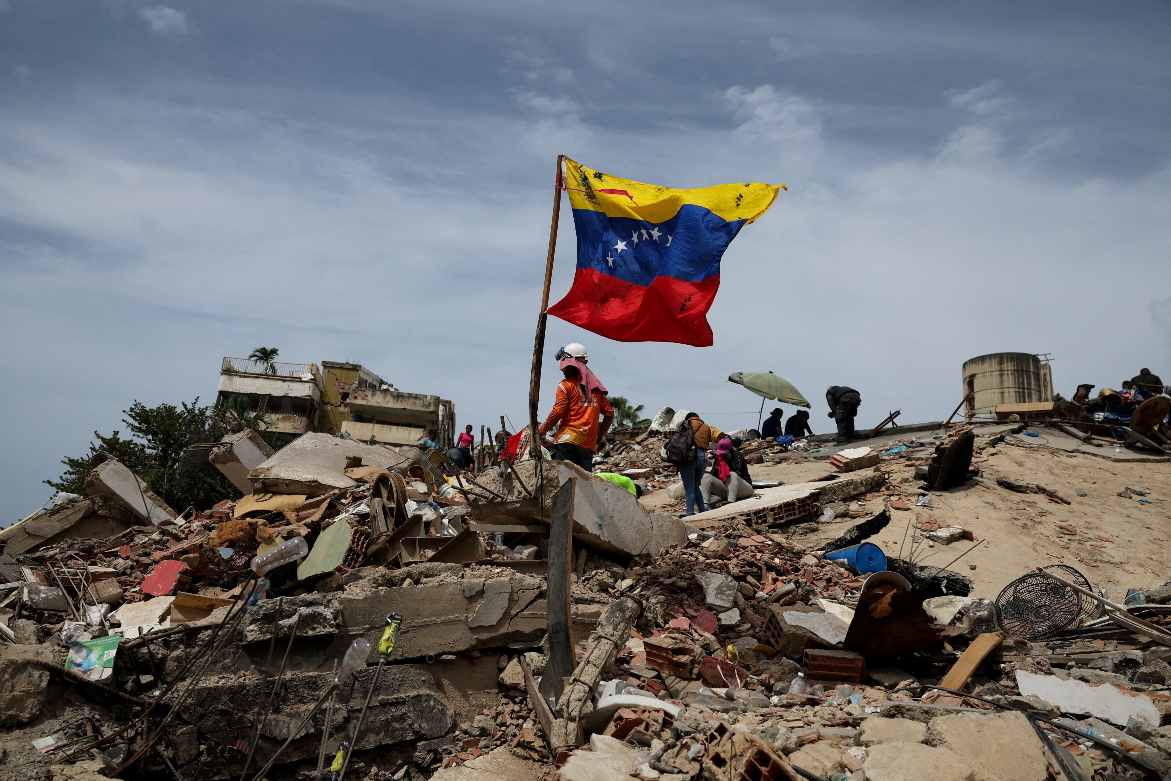 Rescuers search the rubble of a collapsed building on Sunday. Photo: Reuters