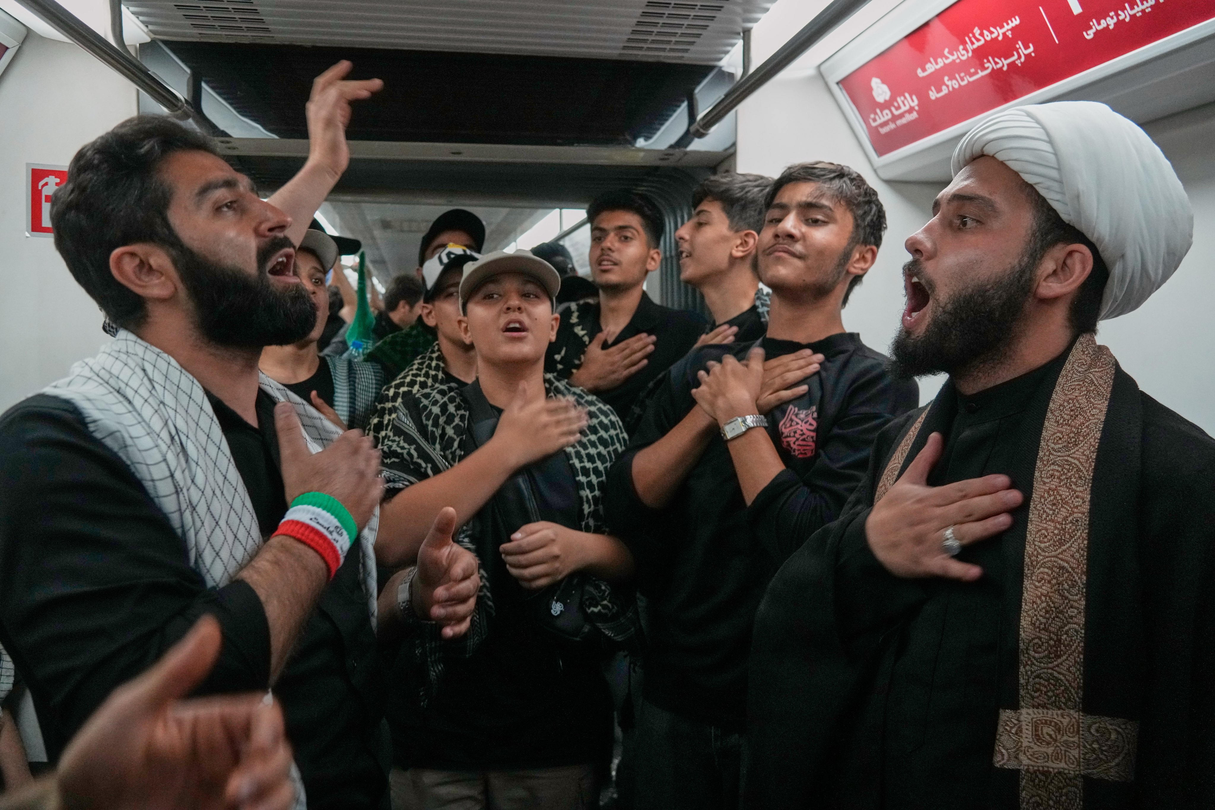Men on a subway train as they travel to attend the funeral procession. Photo: AP