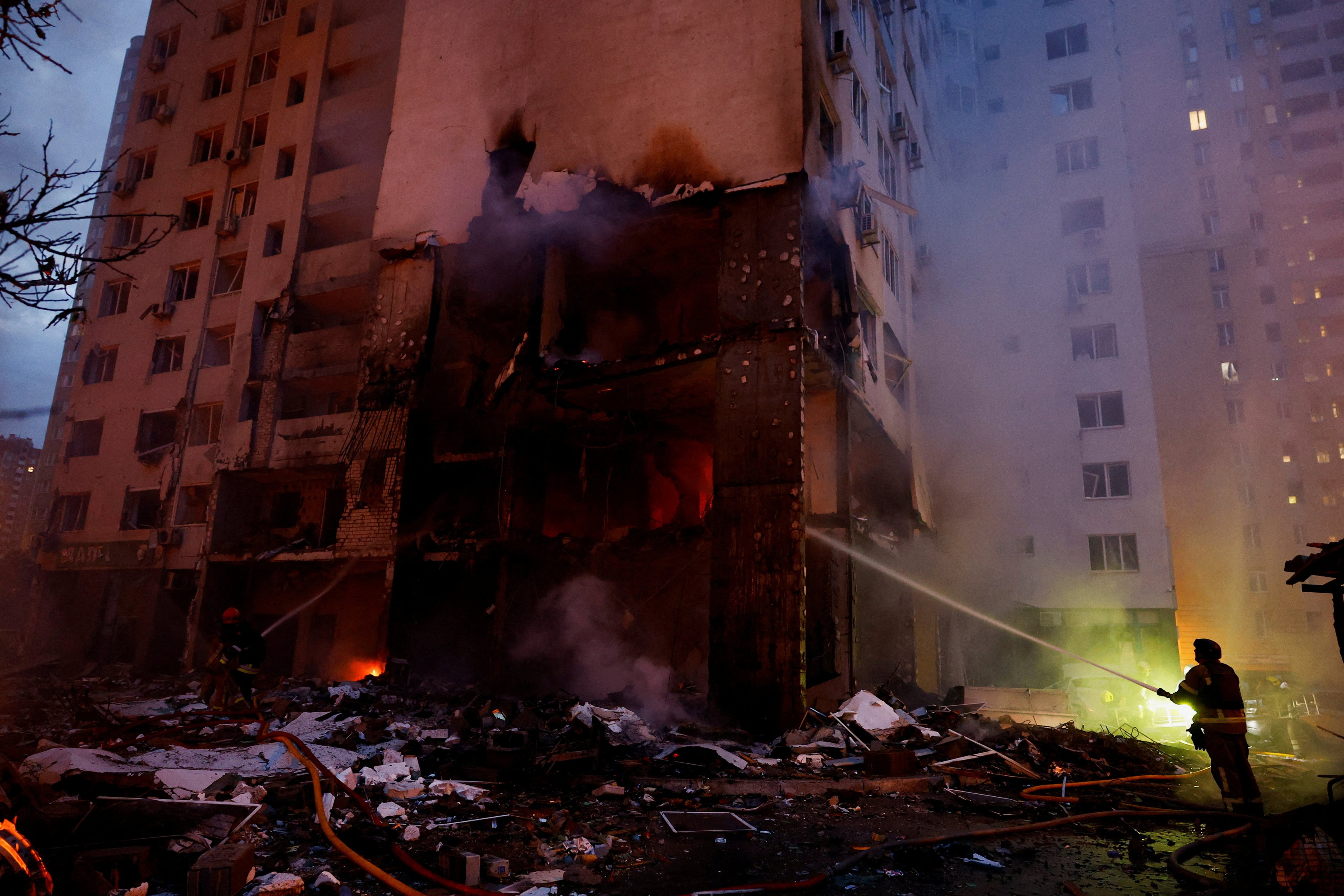 Firefighters at the scene of an aerial attack in Kyiv. Photo: Reuters