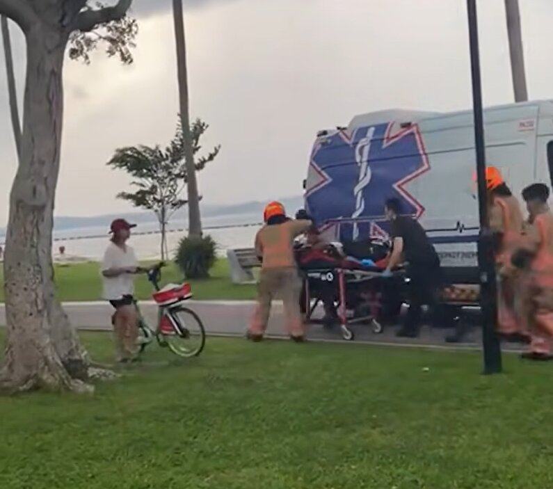Rescuers rush a person to an ambulance at Pasir Ris Beach on Sunday. Photo: TikTok/singaporeincidents.sg