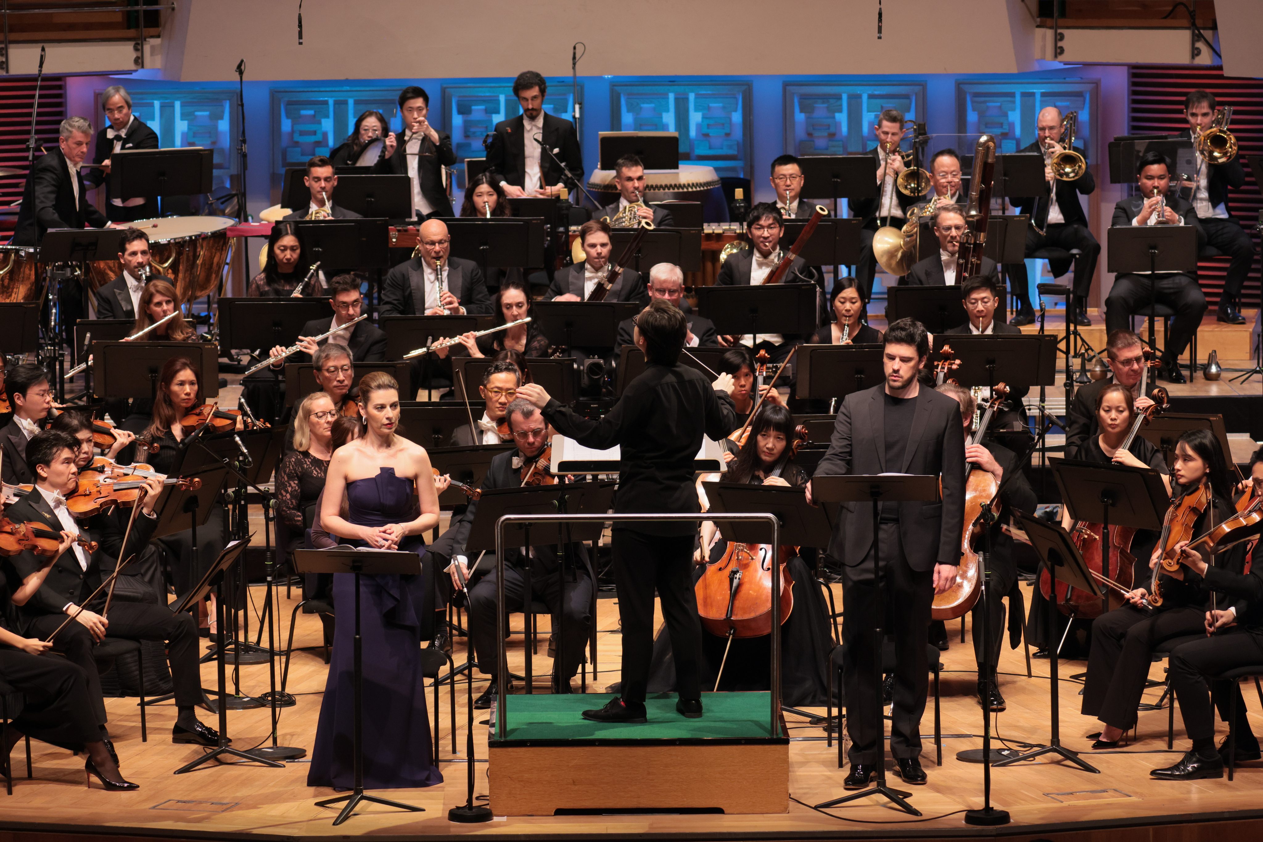 With Tarmo Peltokoski conducting, soprano Chen Reiss (left) and bass-baritone Andre Schuen (right) on stage with the Hong Kong Philharmonic Orchestra and three choirs for Ralph Vaughan Williams’ A Sea Symphony at the Hong Kong Cultural Centre on July 3, 2026. Photo: HK Phil/Keith Hiro