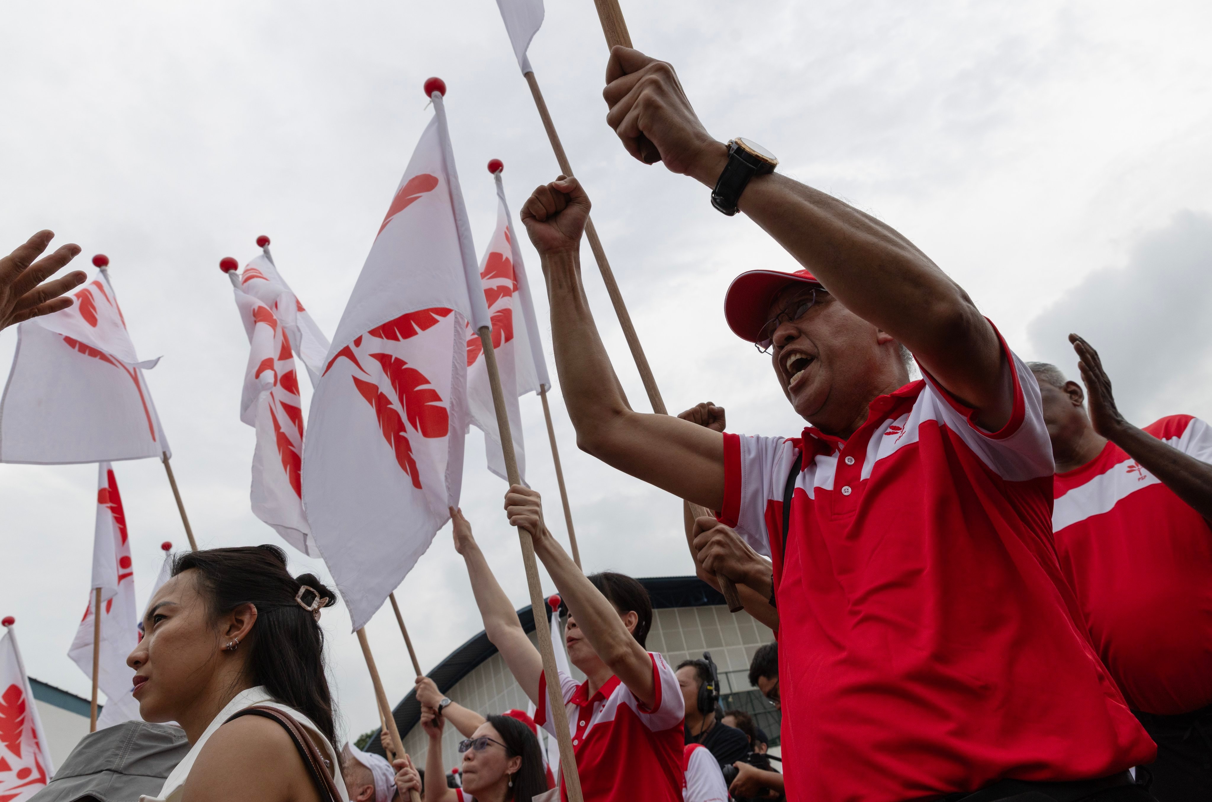 Progress Singapore Party supporters wave flags at a nomination centre on Apriil 23, 2025. Photo: EPA-EFE