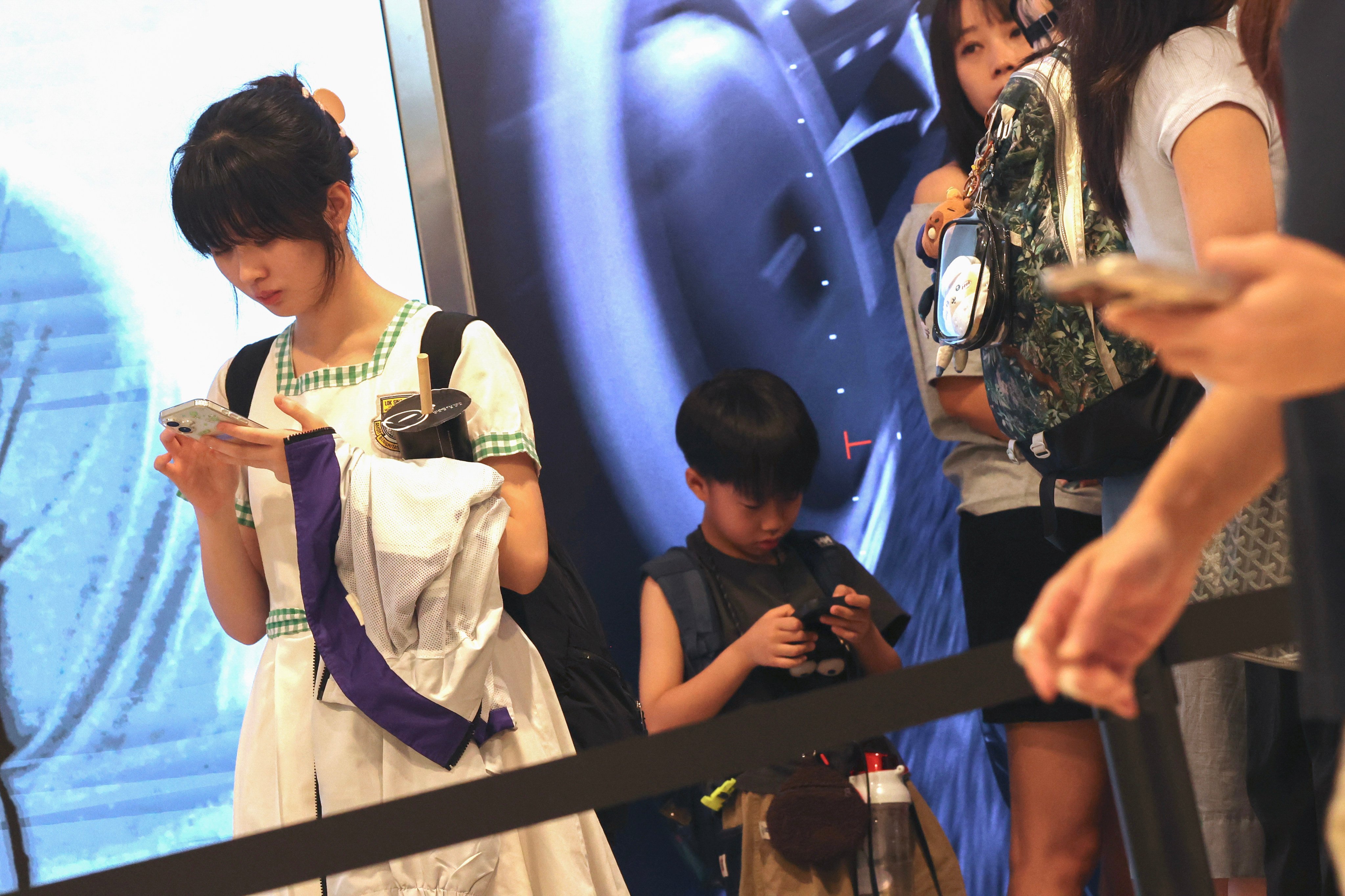 Youths use mobile phones in a mall in Hong Kong’s Central district. The city should introduce a social media ban for youth, following the example set by Australia and other jurisdictions. Photo: Jelly Tse