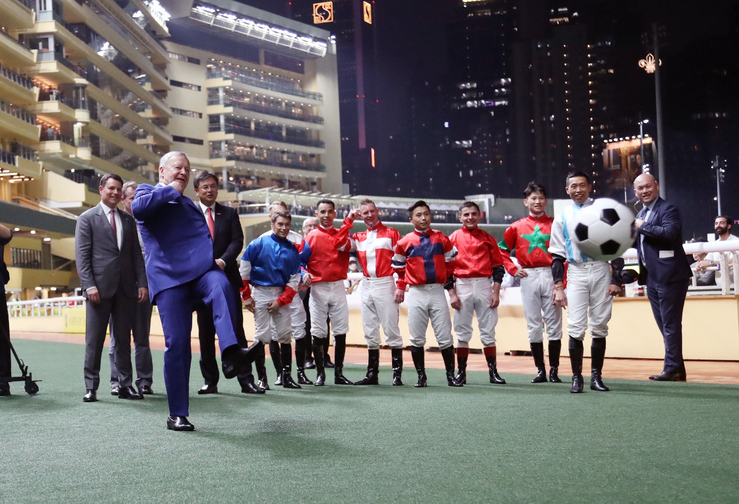 Jockeys watch on as Jockey Club chief executive Winfried Engelbrecht-Bresges (left) shoots for goal before the "Eight To Glory" race at Happy Valley. Photos: Kenneth Chan