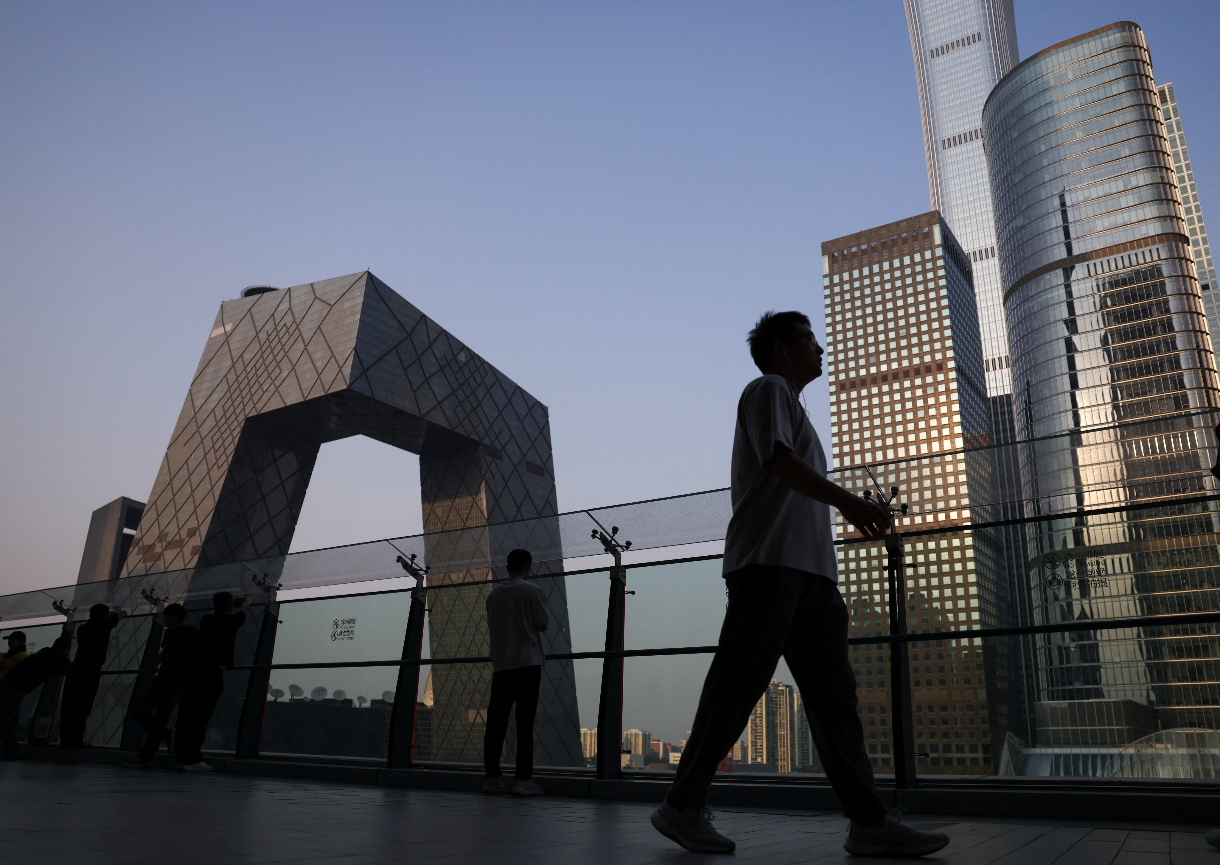 People are seen on the terrace of a shopping mall overlooking the central business district in Beijing. China was the world’s third-largest source of foreign direct investment in 2025. Photo: Reuters