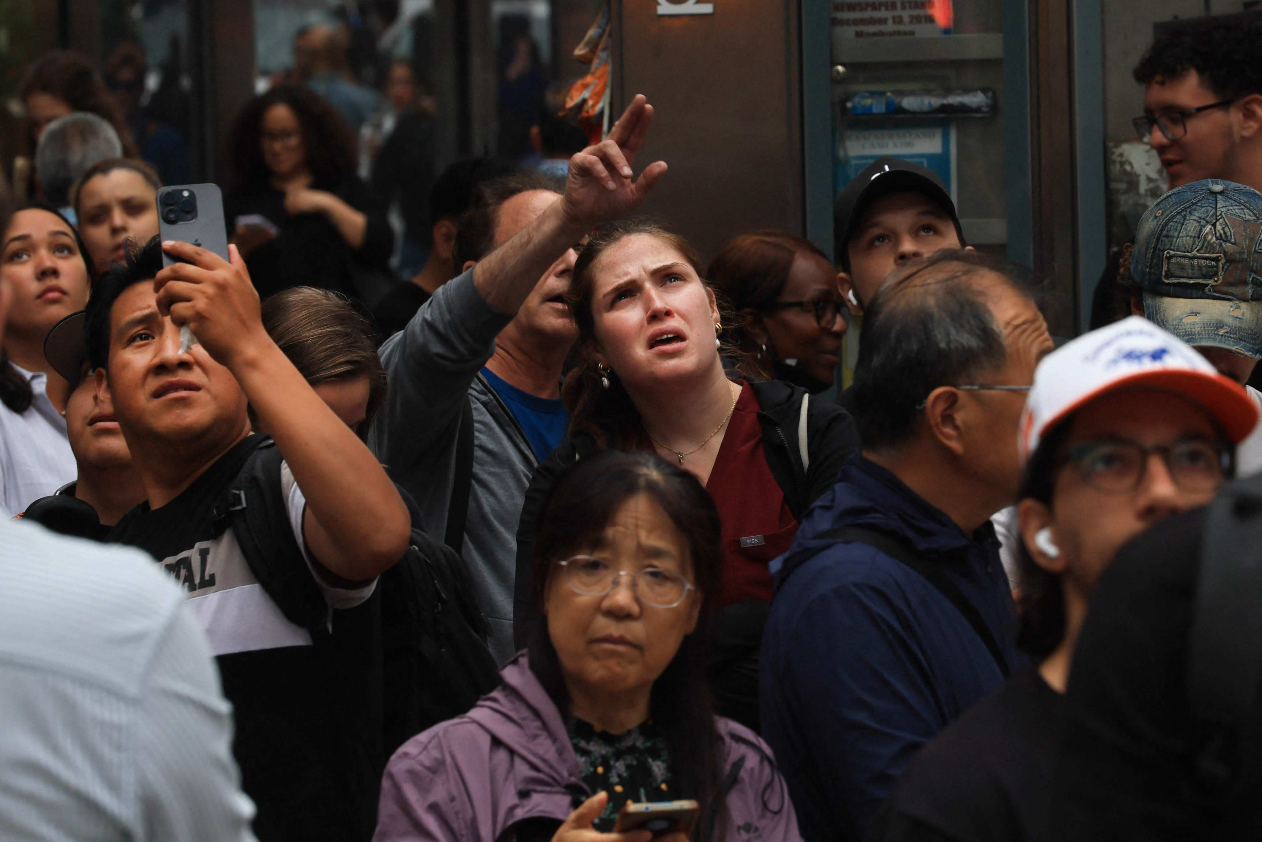 People look up at the building. Photo: AFP