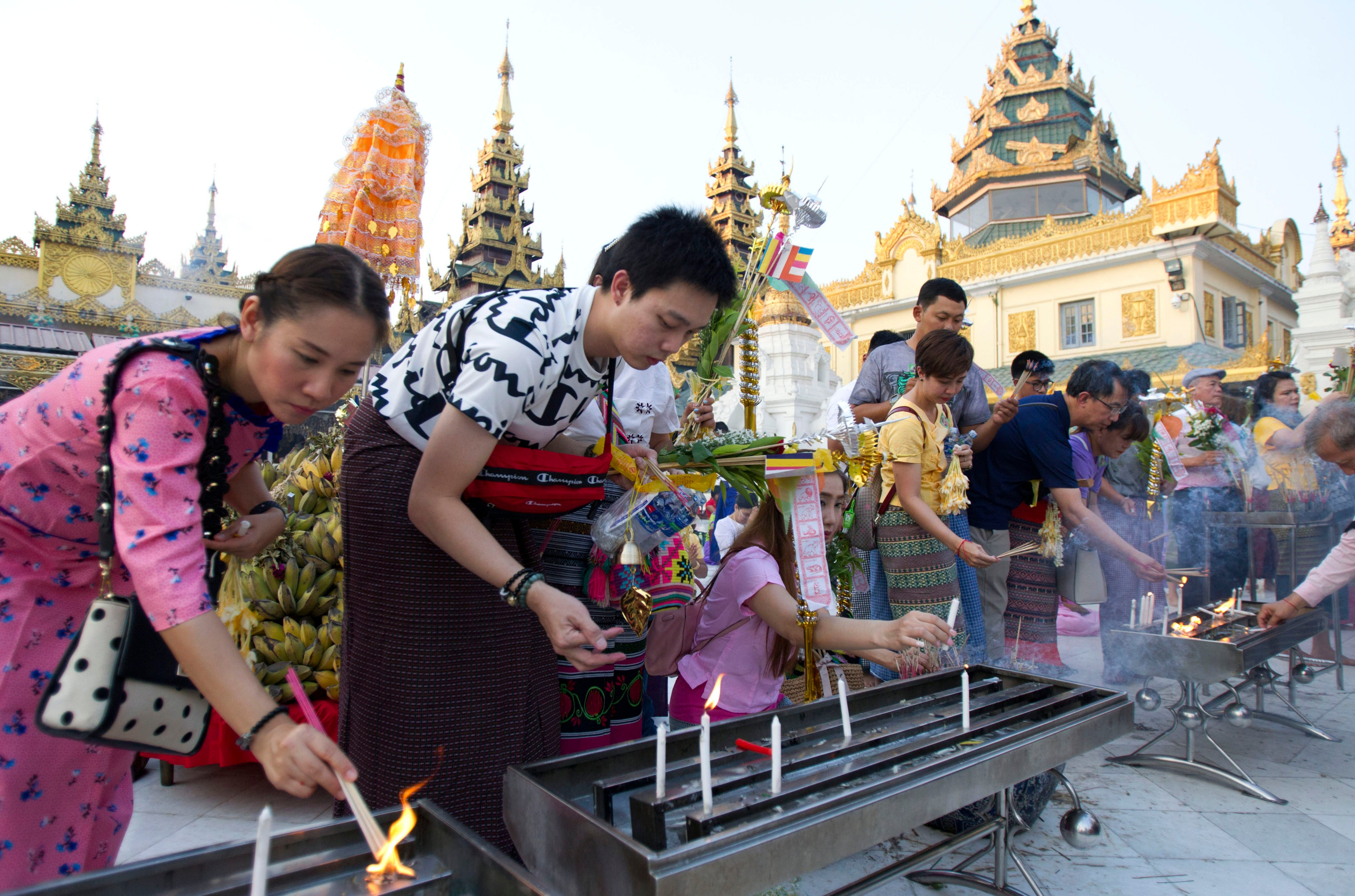 Tourists offer joss sticks at Myanmar’s Shwedagon Pagoda in Yangon in 2019. Photo: AP
