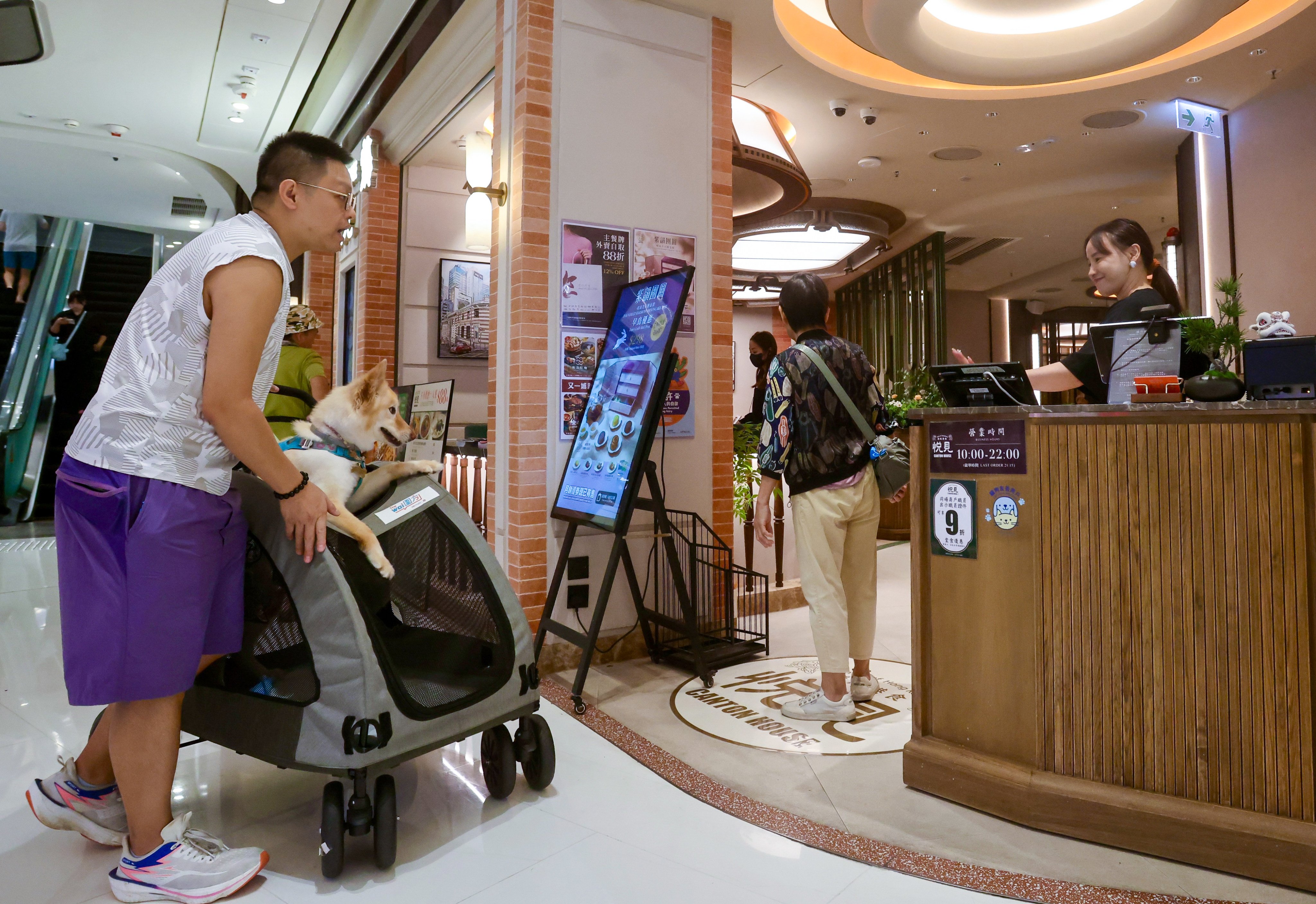 A resident and his pet dog outside Canton House at The Wai shopping centre in Tai Wai. Photo: Jonathan Wong