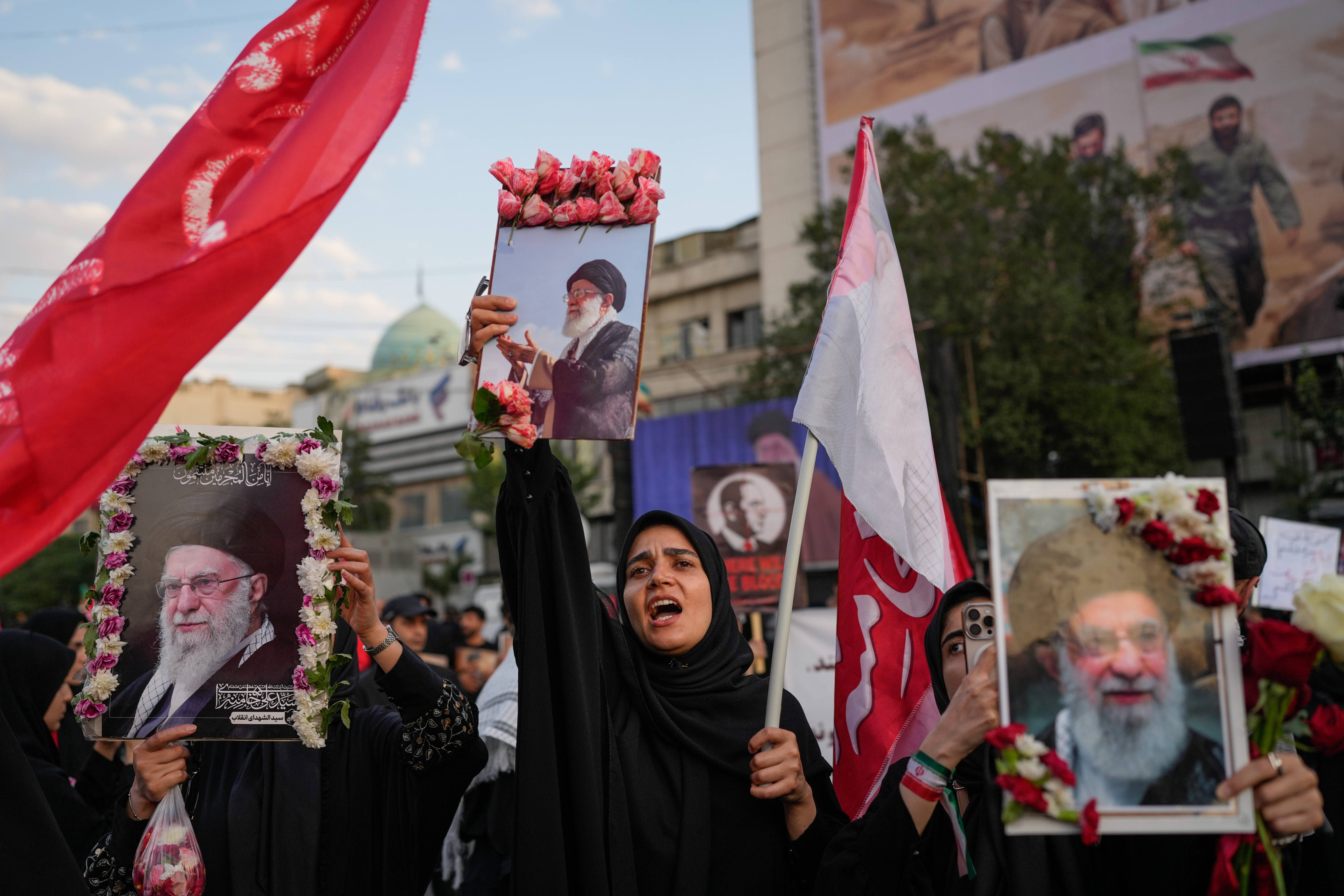 Mourners chant while holding flower-framed portraits of slain Iranian Supreme Leader Ayatollah Ali Khamenei during his funeral procession in Tehran on Monday. Photo: AP