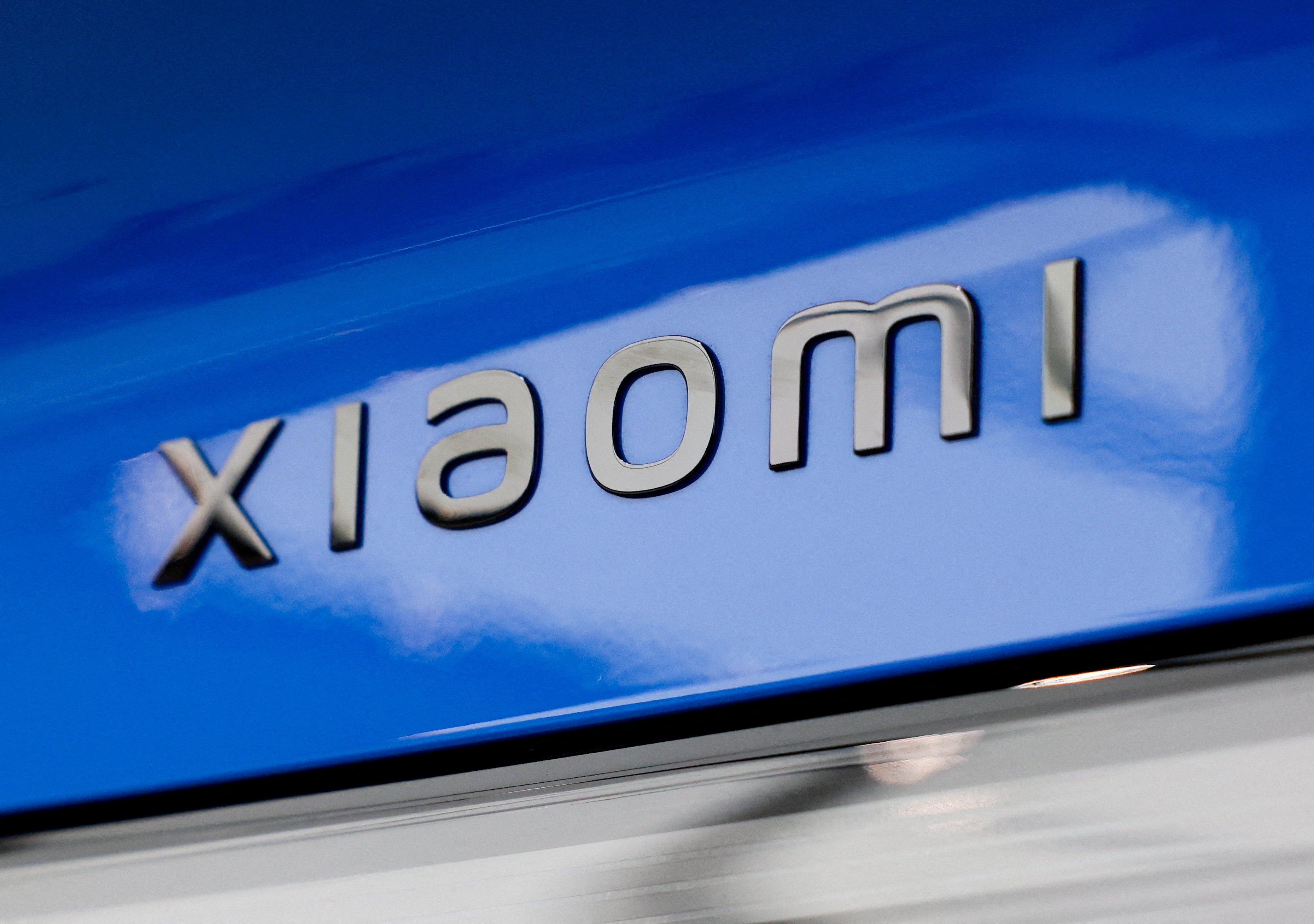 The Xiaomi logo appears on a new‑generation SU7 electric sedan ahead of a launch event in Beijing. Photo: Reuters