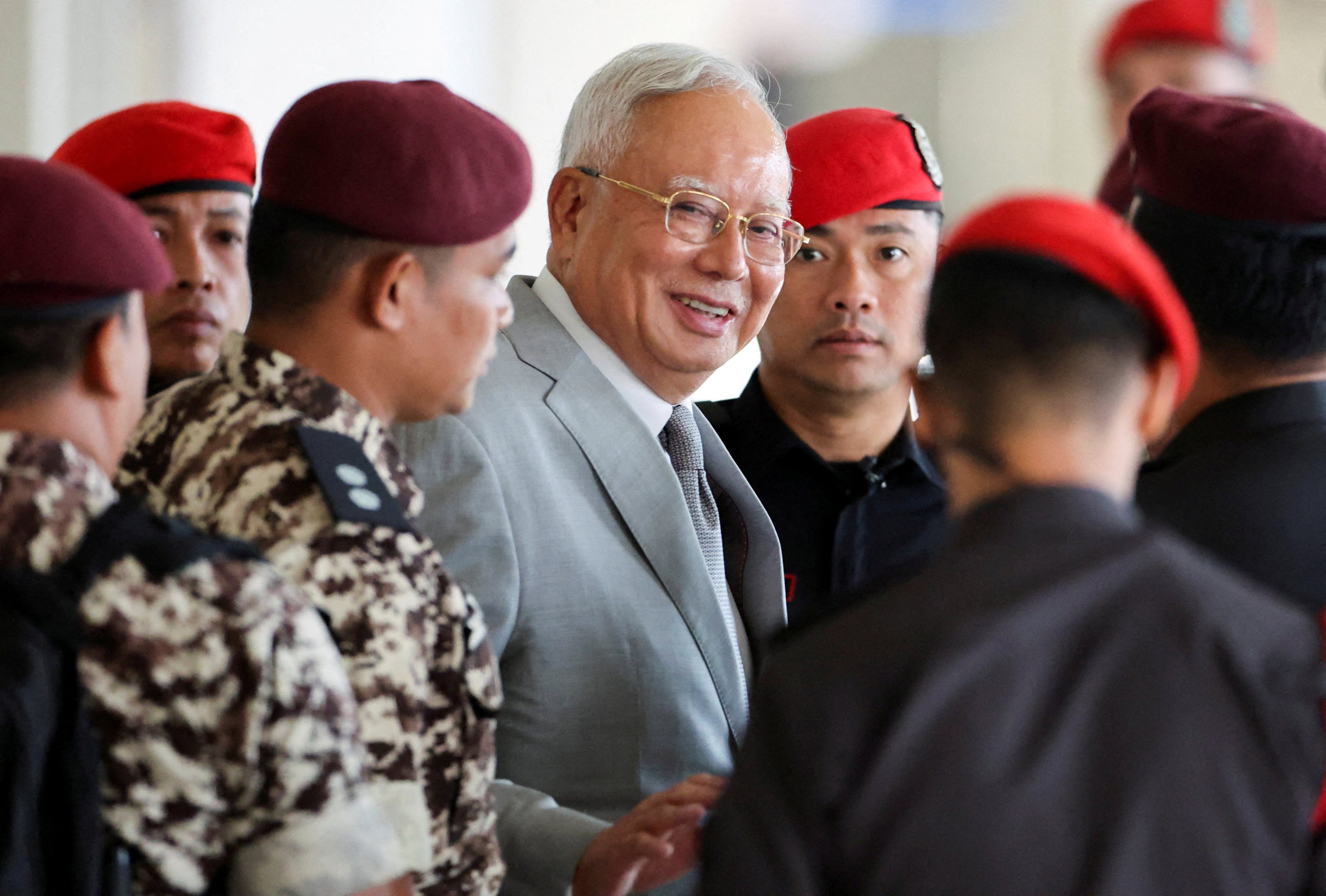 Malaysia’s former prime minister Najib Razak, jailed for corruption in the multibillion-dollar 1MDB scandal, is escorted by prison guards at Kuala Lumpur Courts Complex in 2025. Photo: Reuters