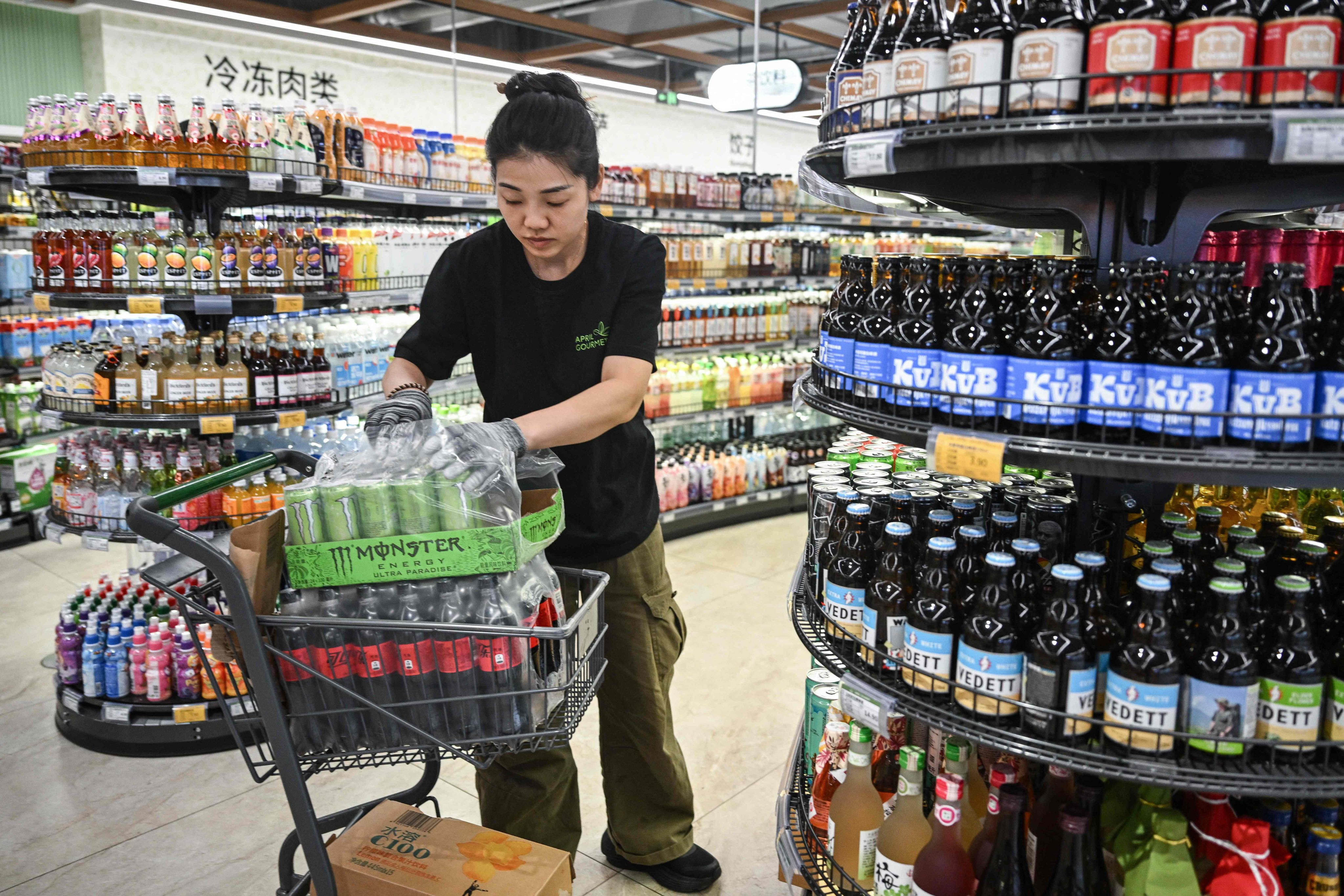 A worker arranges products in a store in Beijing last month. Photo: AFP