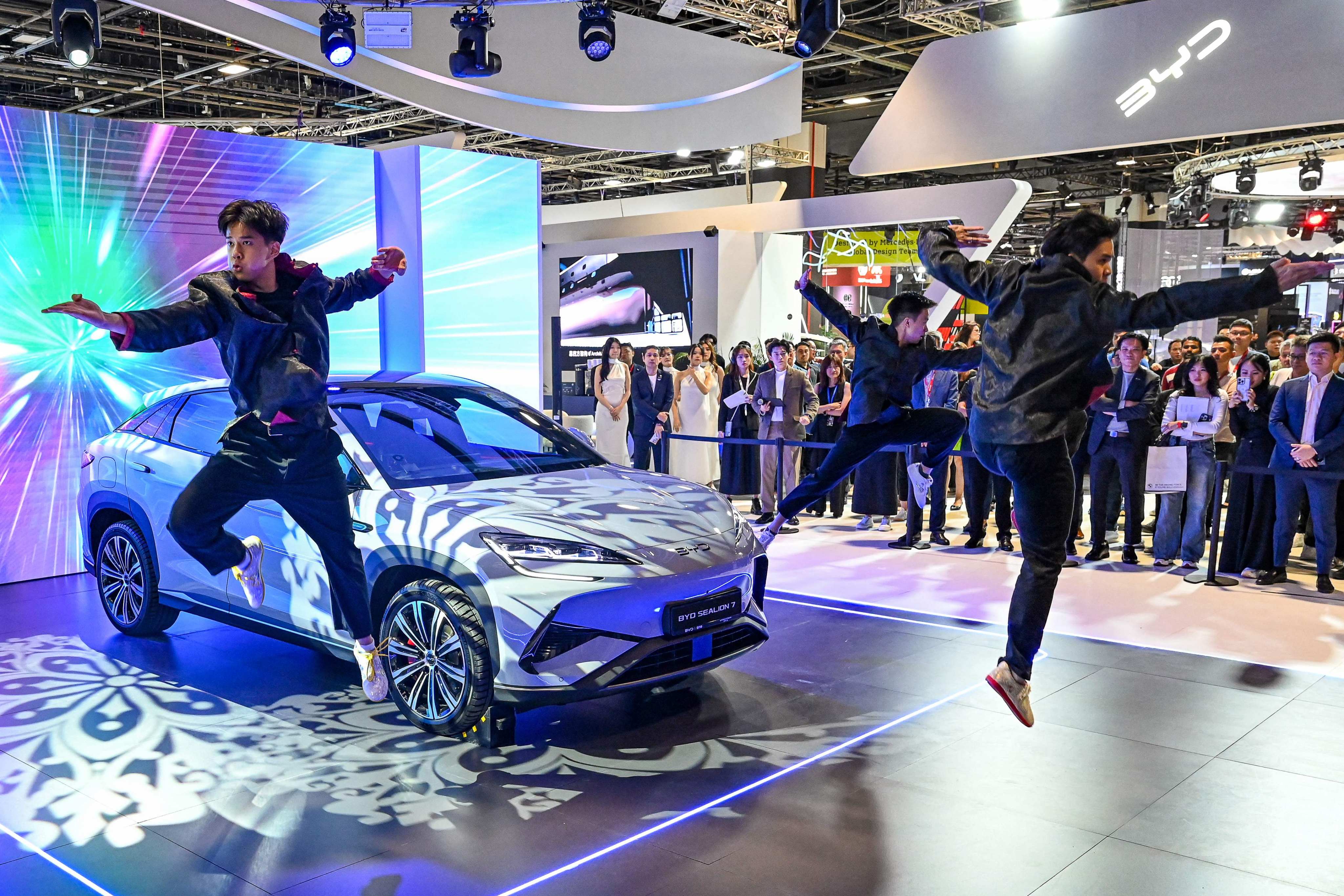 Practitioners perform martial arts next to a BYD electric car during a motor show in Singapore last year. Photo: AFP