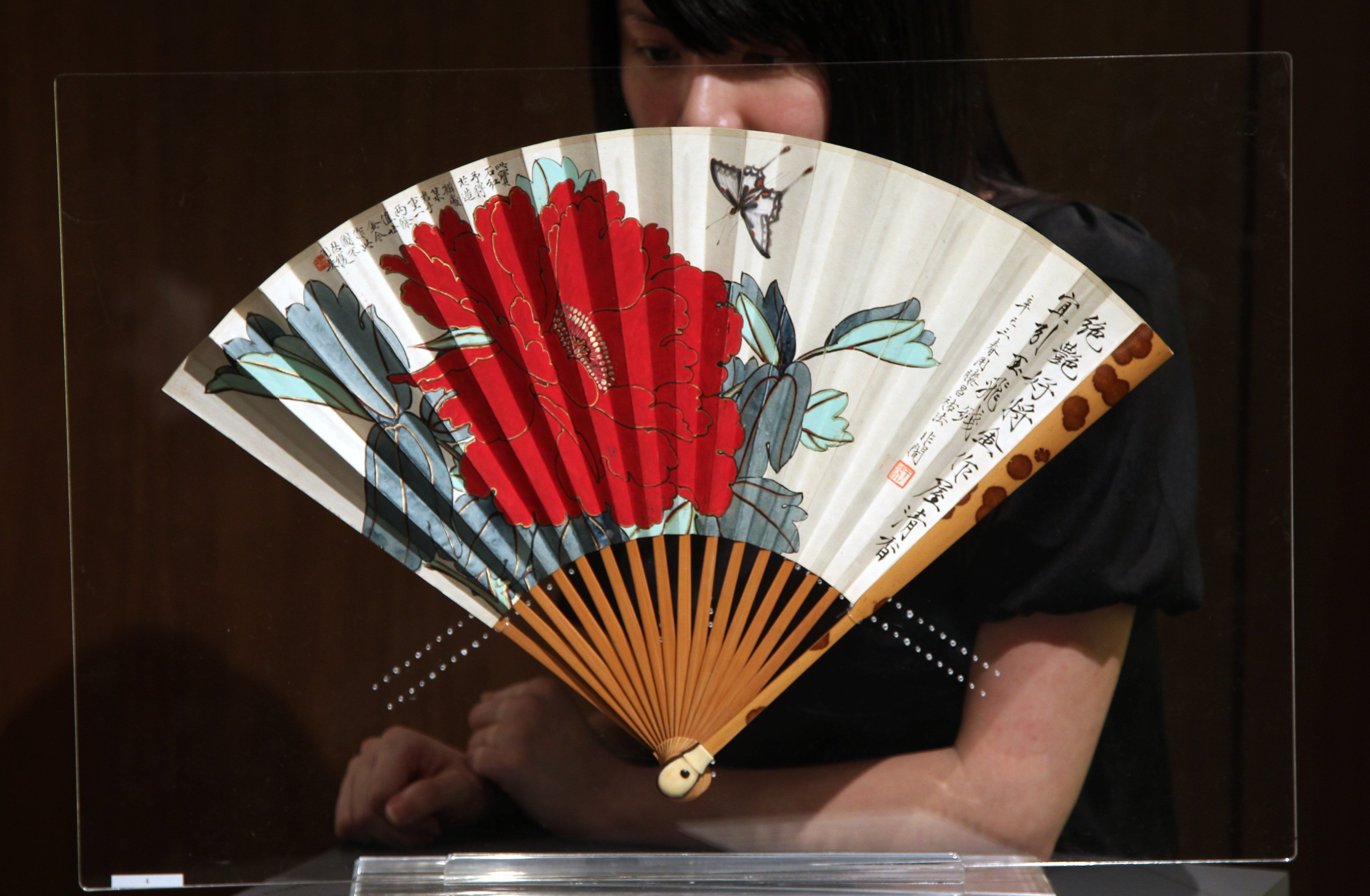 A folding fan painted by Chinese artist Yu Feian (1889-1959) at an auction preview at Sotheby’s Hong Kong in 2010. As well as helping to beat the summer heat, fans have been used in China for centuries to mark status and as works of art. Photo: Sam Tsang