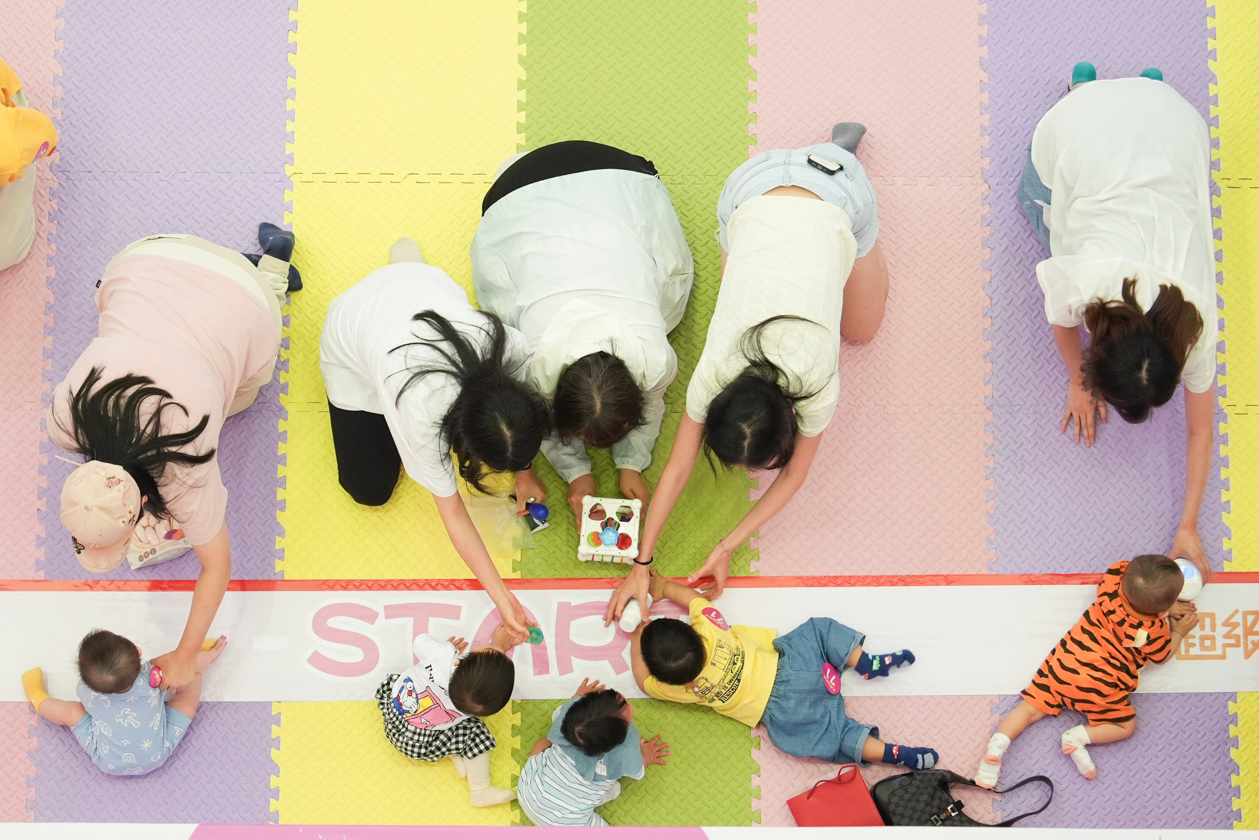 Babies and their parents take part in a Mother’s Day competition at a Tai Po shopping centre. Photo: Eugene Lee