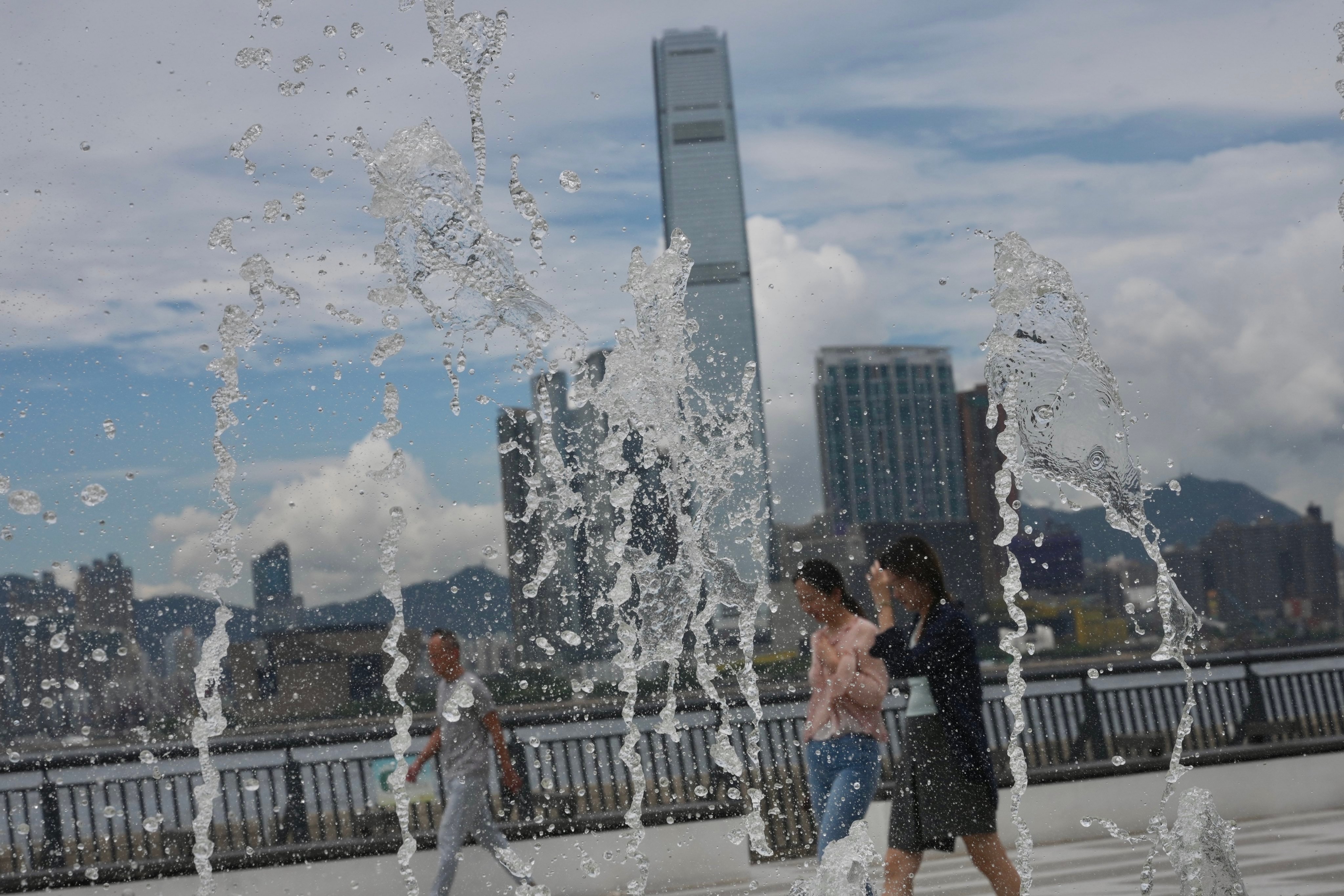 Pedestrians walk past water fountains at Sun Yat Sen Memorial Park in Sai Ying Pun, as temperatures reached around 33 degrees on Friday. Photo: Karma Lo