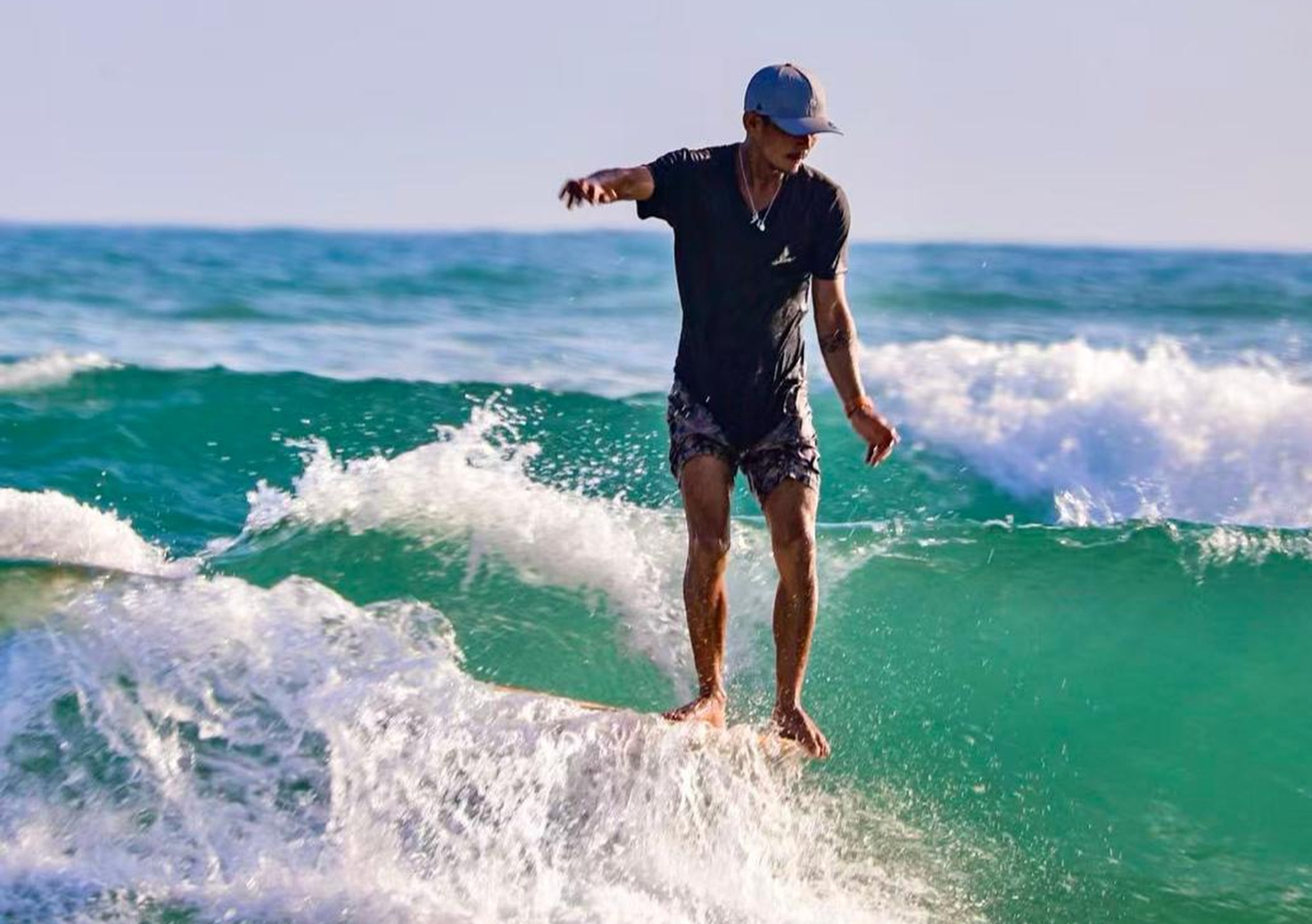Huang Xing, who helps manage a surf club in Wanning, Hainan province, tests the waves Photo: courtesy of Xie Yao