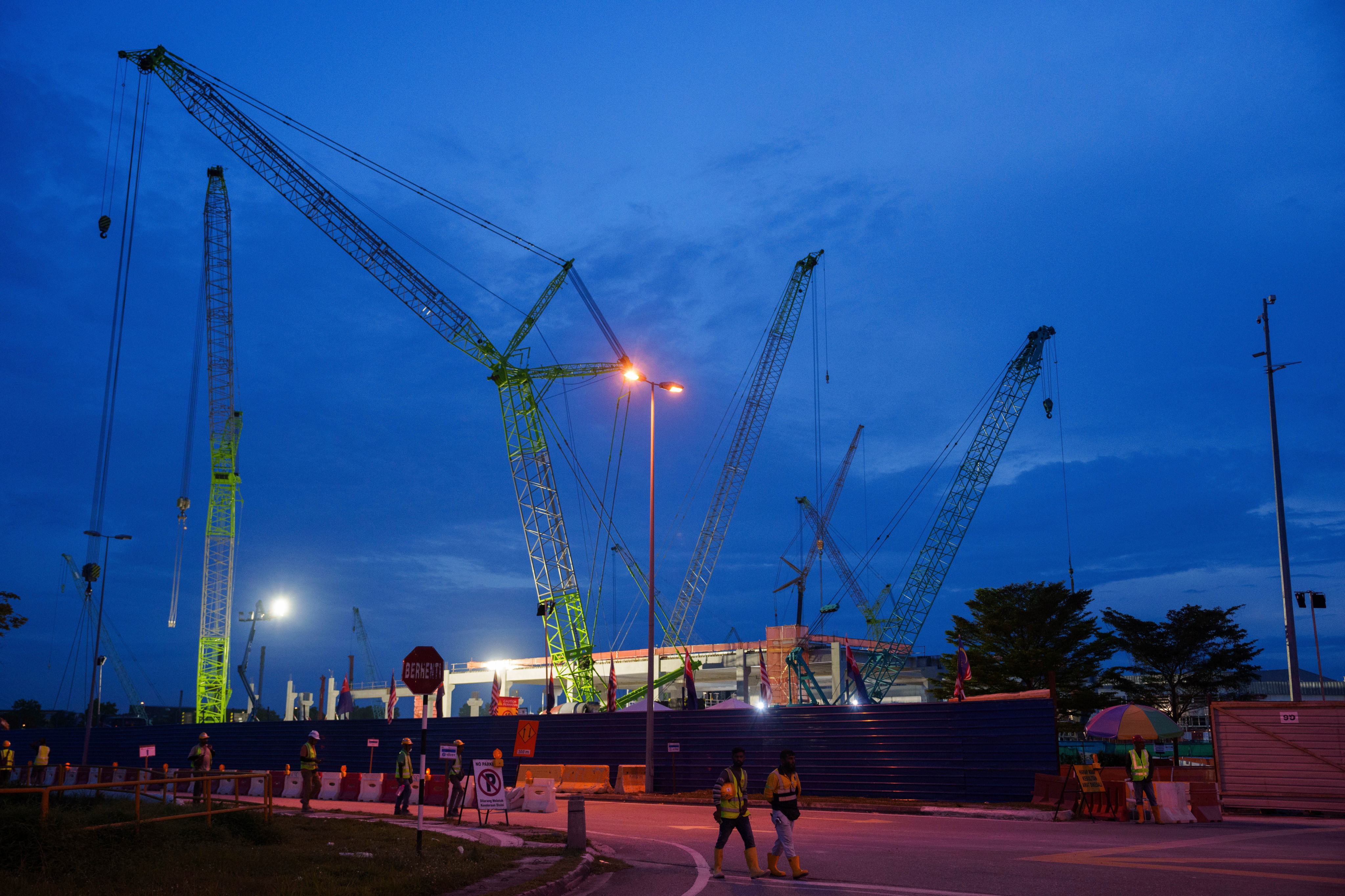 Workers walk outside a data centre building under construction in Johor Bahru Malaysia, on September 28, 2024. Photo: AP
