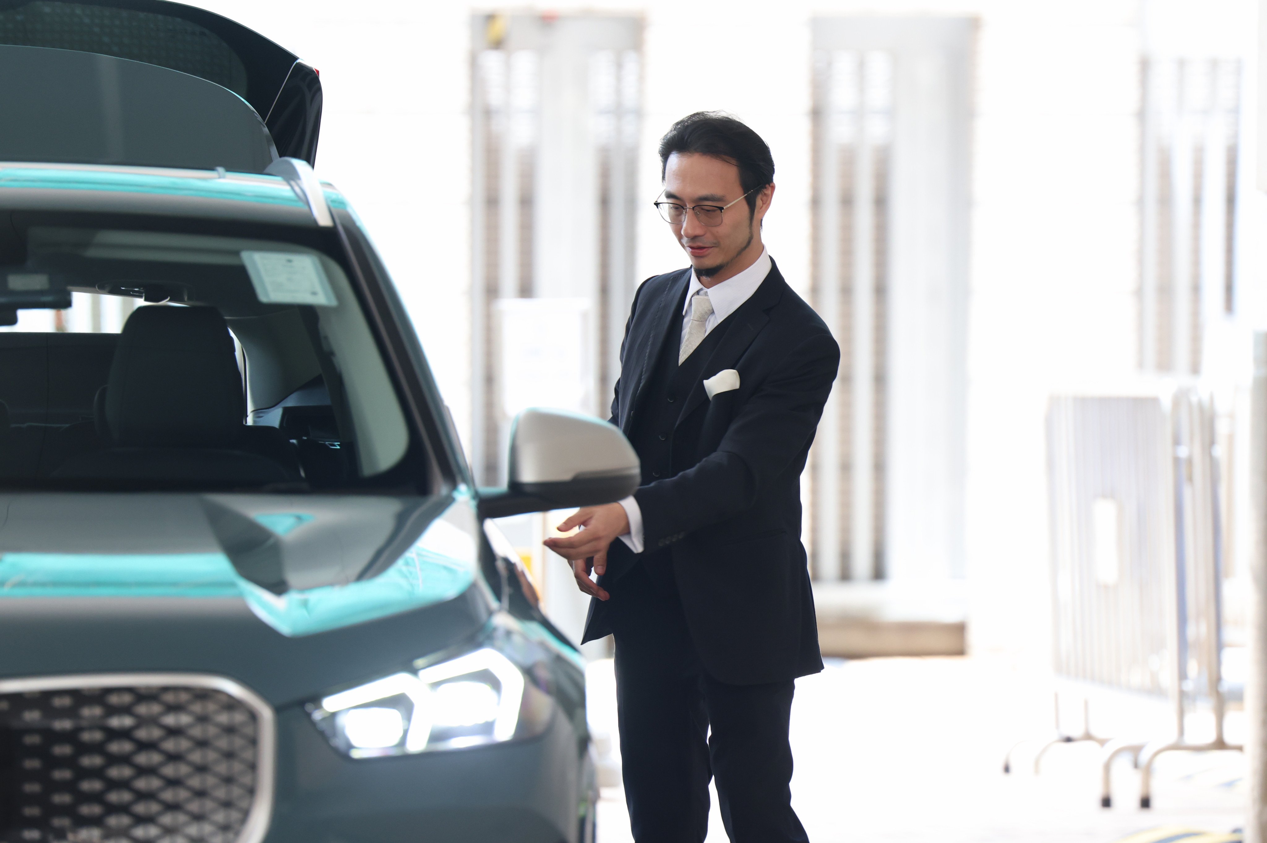 Franco Kuan leaves West Kowloon Court after an unrelated hearing on Friday. He appeared at Sha Tin Court earlier in the day to face charges of dangerous driving and driving under the influence of alcohol. Photo: Brian Wong