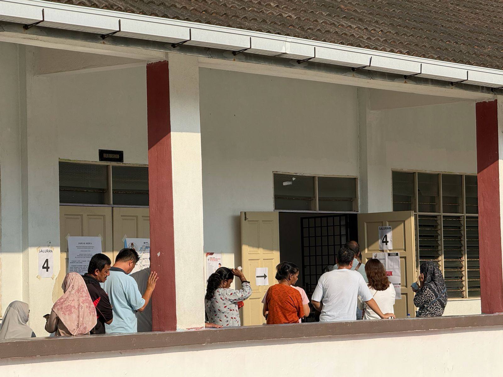 Voters wait outside a polling station in Puteri Wangsa, Johor, on Saturday. Photo: Iman Muttaqin Yusof