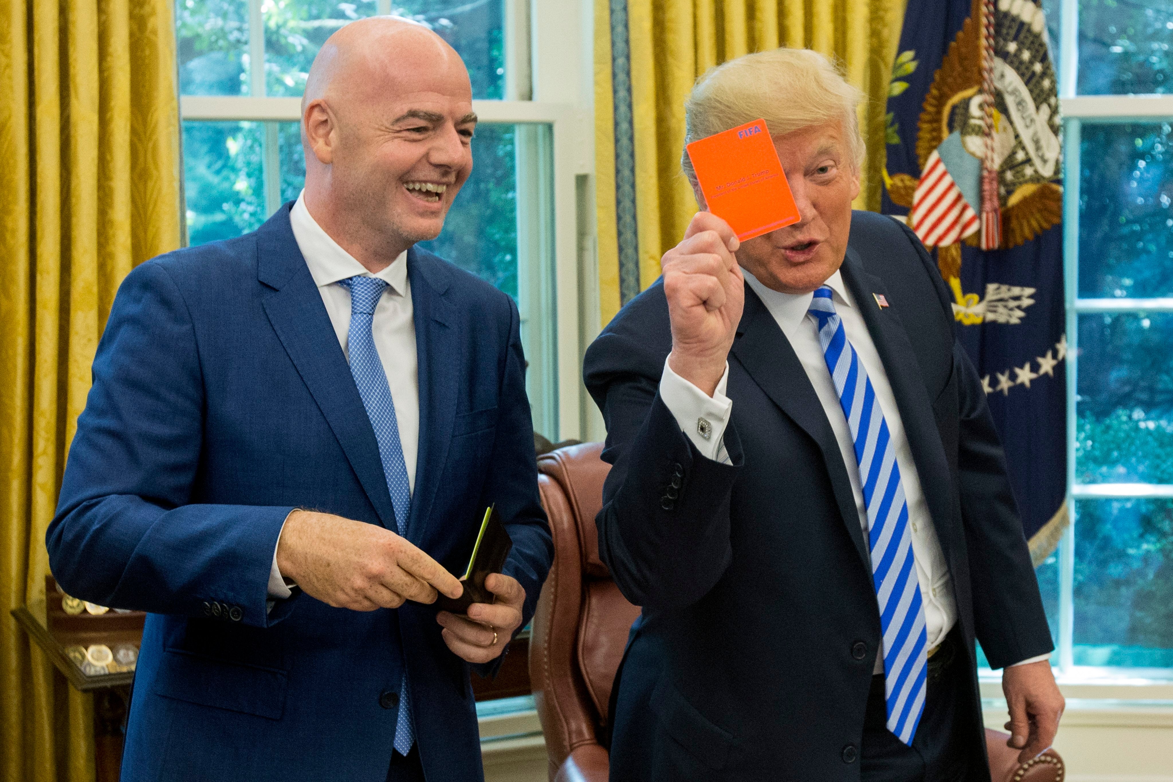 US President Donald Trump holds up a Fifa red card that bears his name, given to him by the association’s president Gianni Infantino (left) during their meeting at the White House in Washington on August 28, 2018. File photo: EPA-EFE