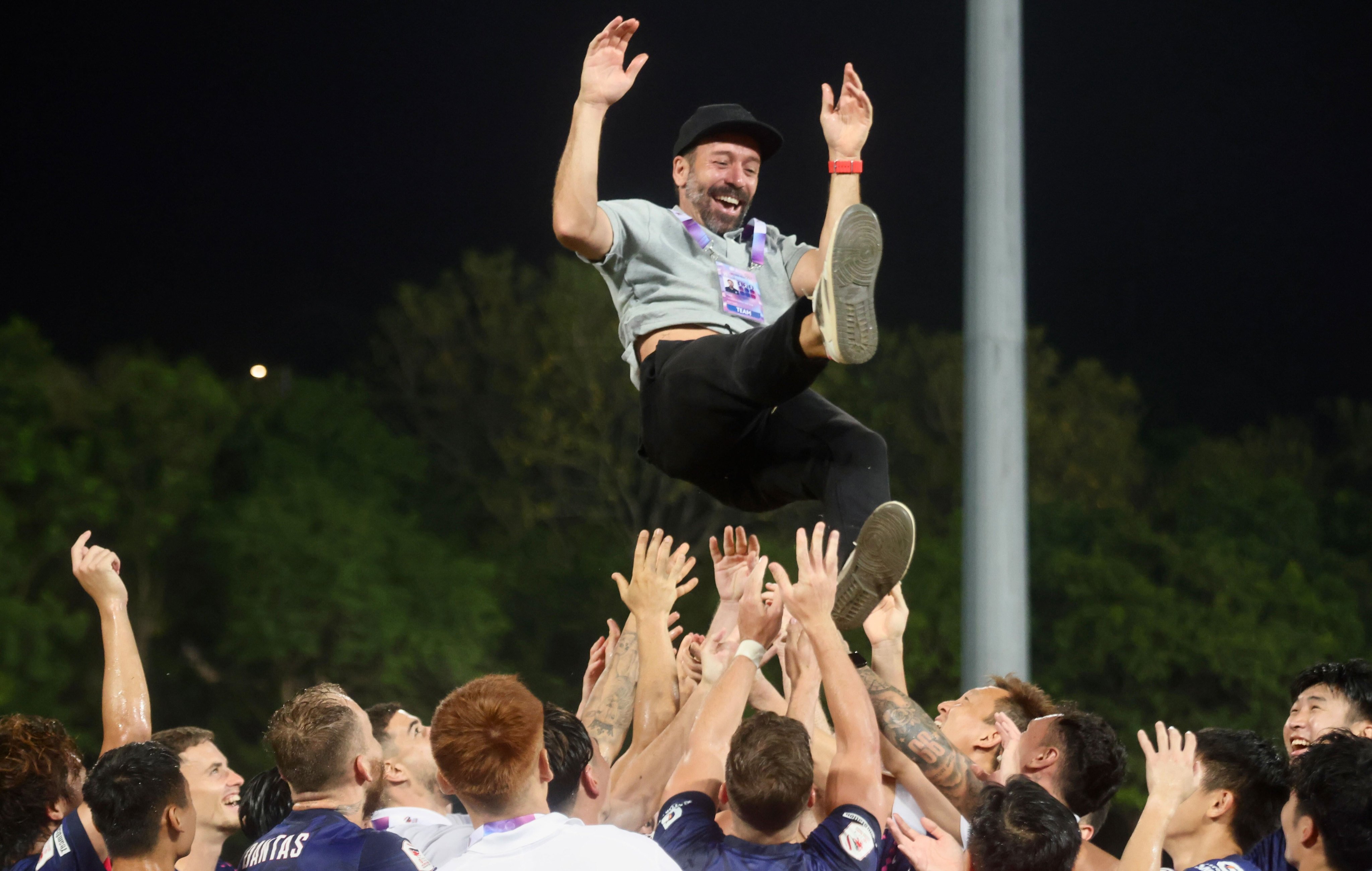 Inigo Calderon is tossed in the air by his players after Kitchee wrapped up the league title last season. Photo: Jonathan Wong