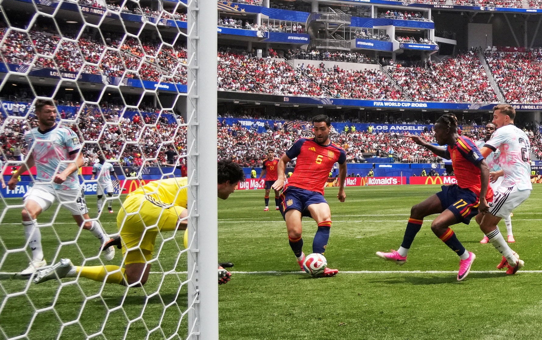 Mikel Merino (middle) places home his winning goal for Spain past replacement Belgian goalkeeper Senne Lammens. Photo: Reuters