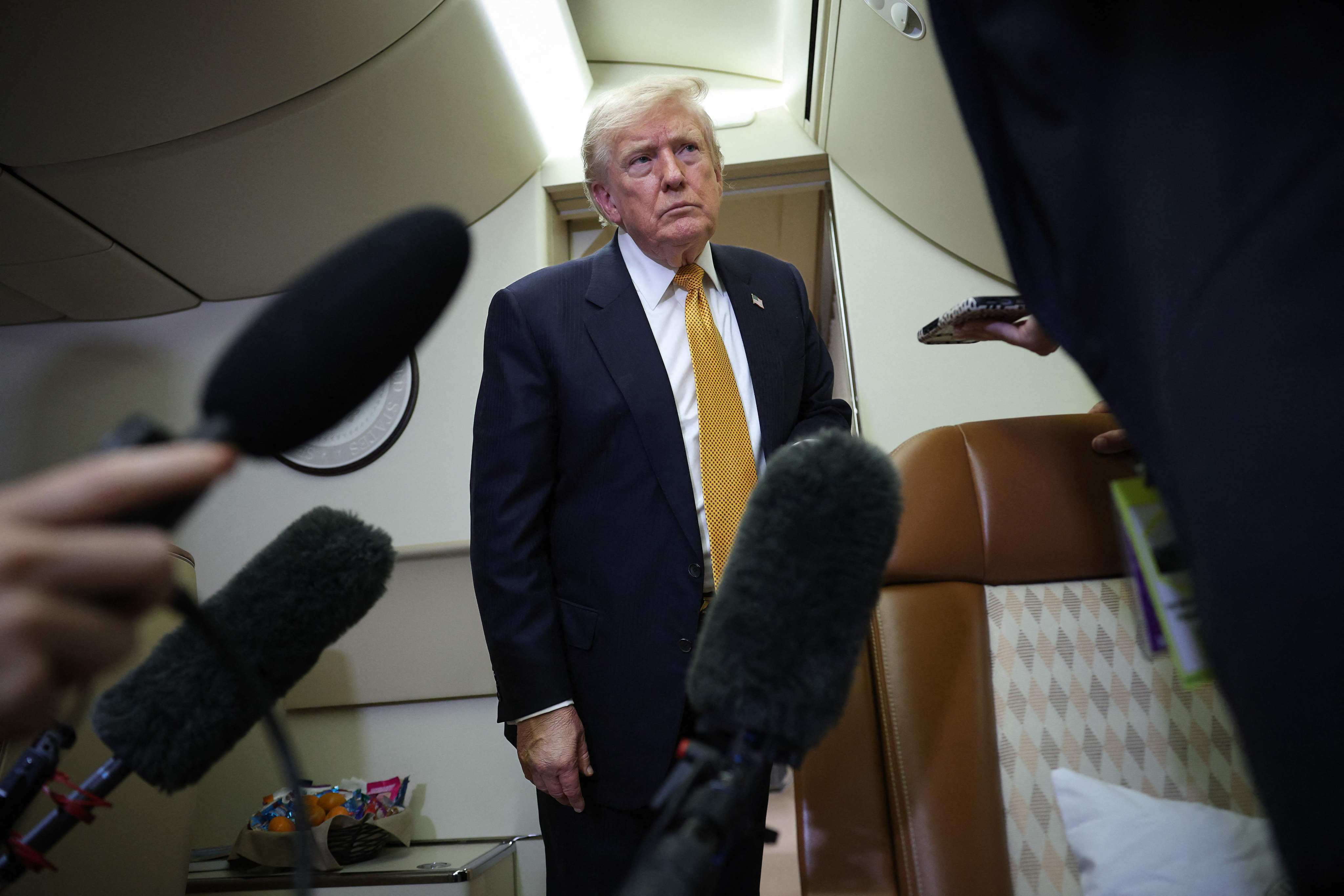 US President Donald Trump speaks to members of the press for the first time aboard the new Air Force One while in flight from RAF Mildenhall AFB to Joint Base Andrews on Wednesday. Photo:   AFP