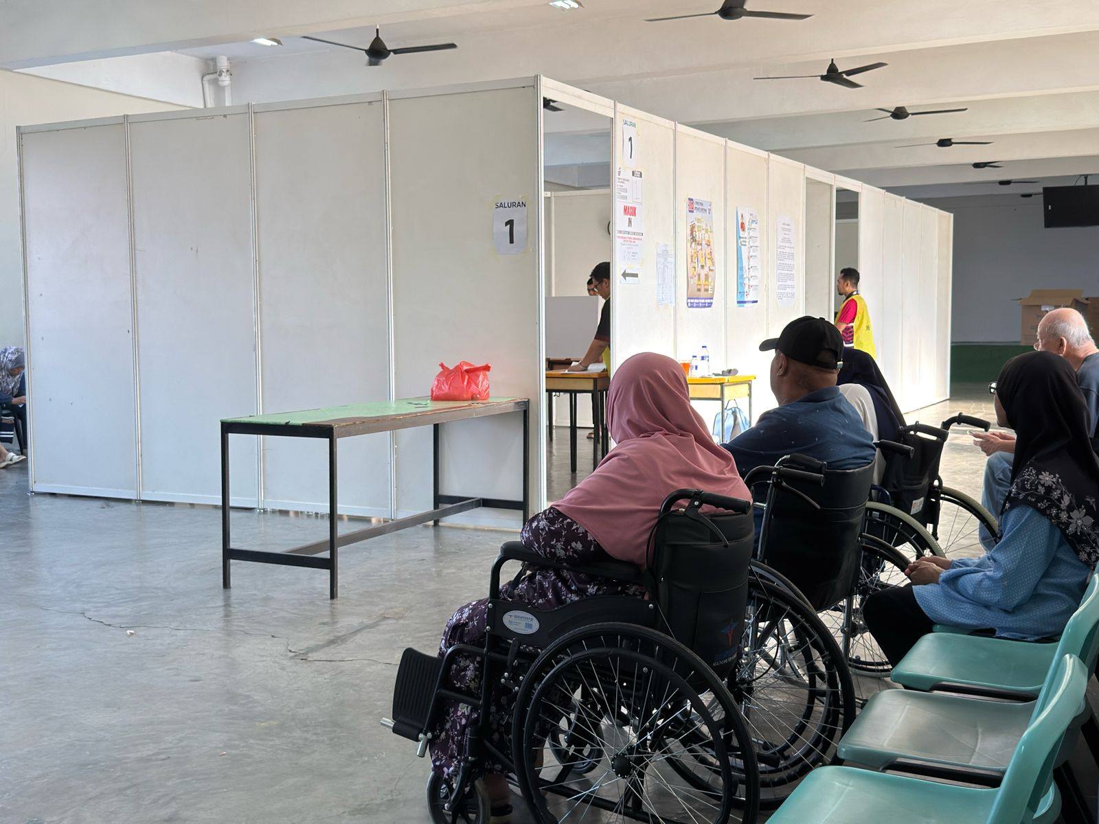 Voters wait to cast their ballots inside a polling centre in Puteri Wangsa, Johor, on Saturday. Photo: Iman Muttaqin Yusof
