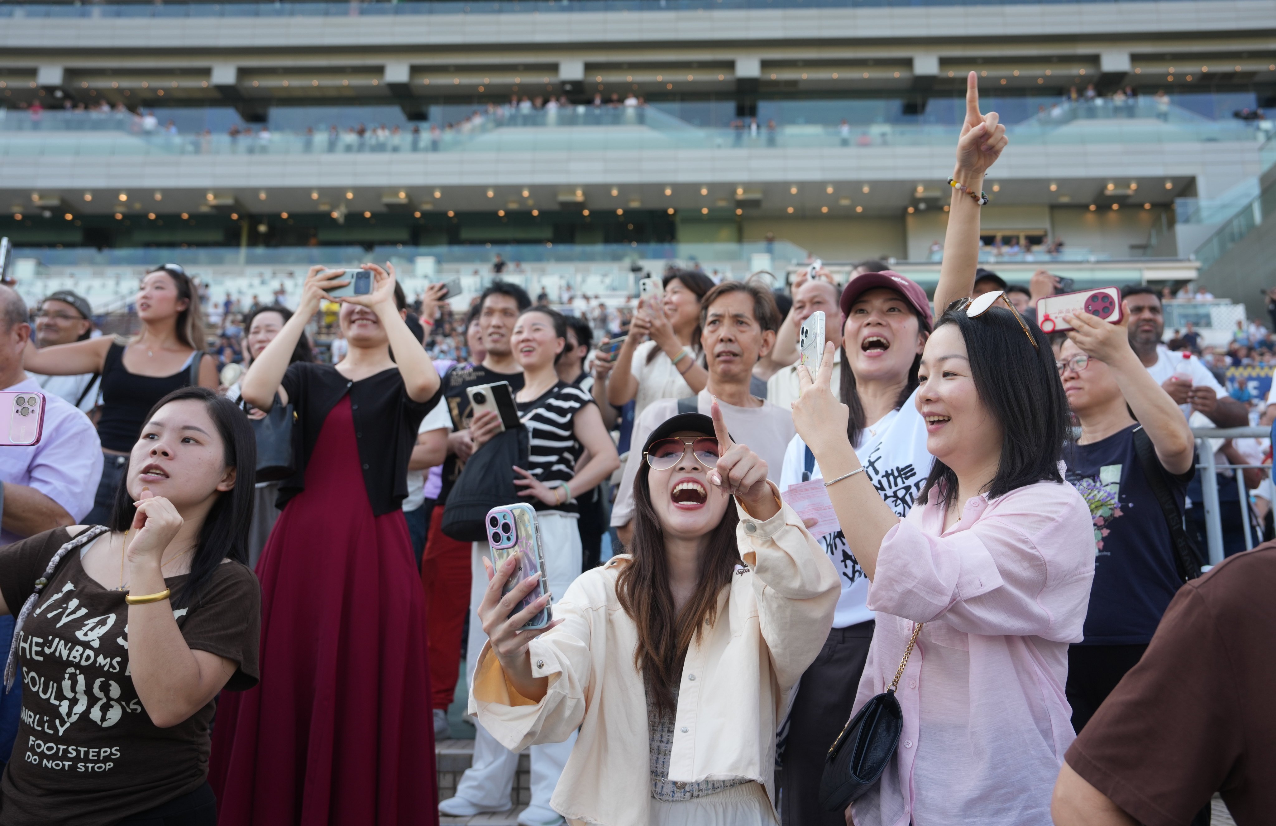 Racing fans cheer on  their favourites at Sha Tin during the penultimate meet of the Hong Kong season. Photo: Sam Tsang