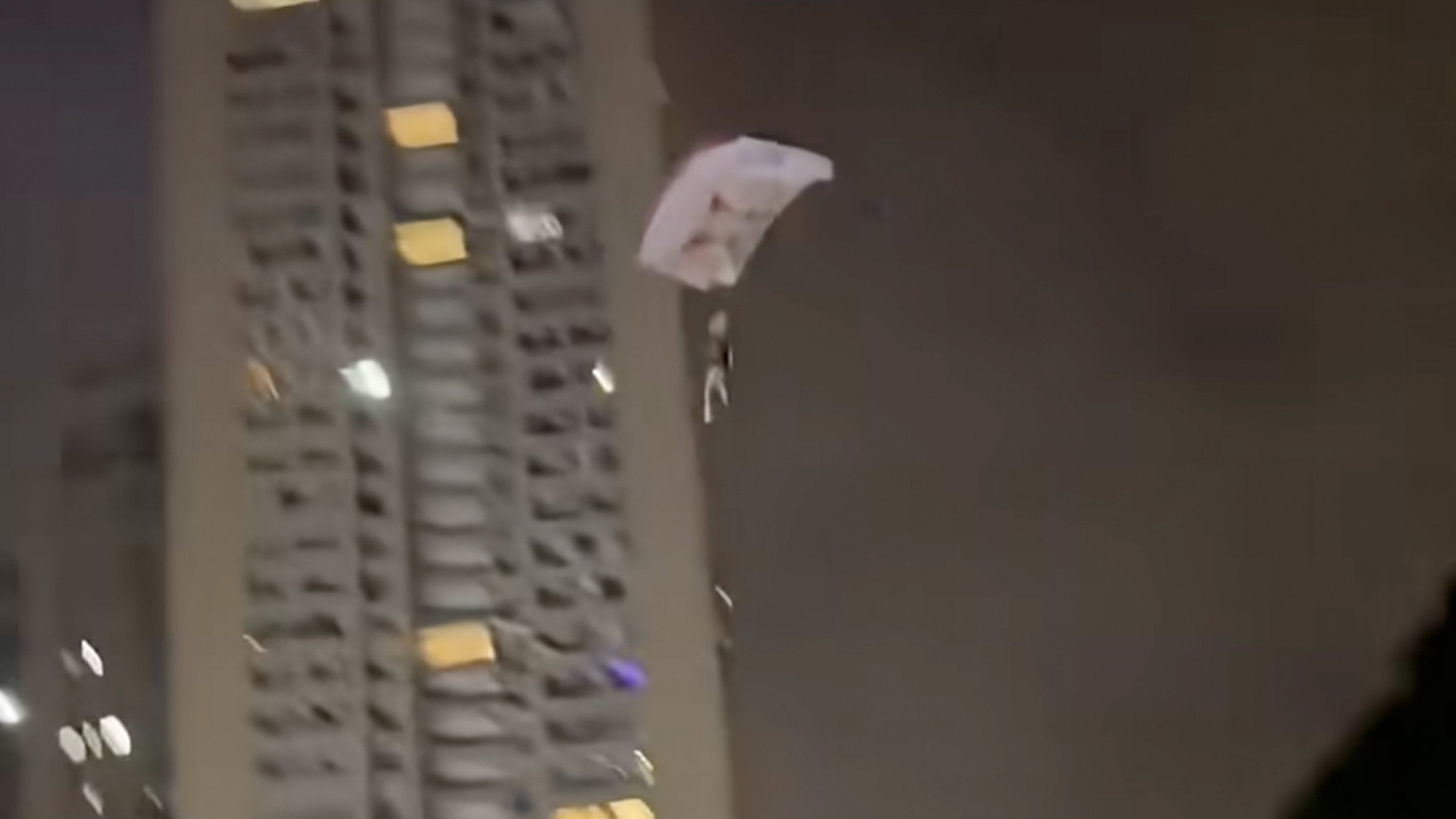 A man in Chengdu was arrested after parachuting off a residential building just to get online attention. Photo: Weibo