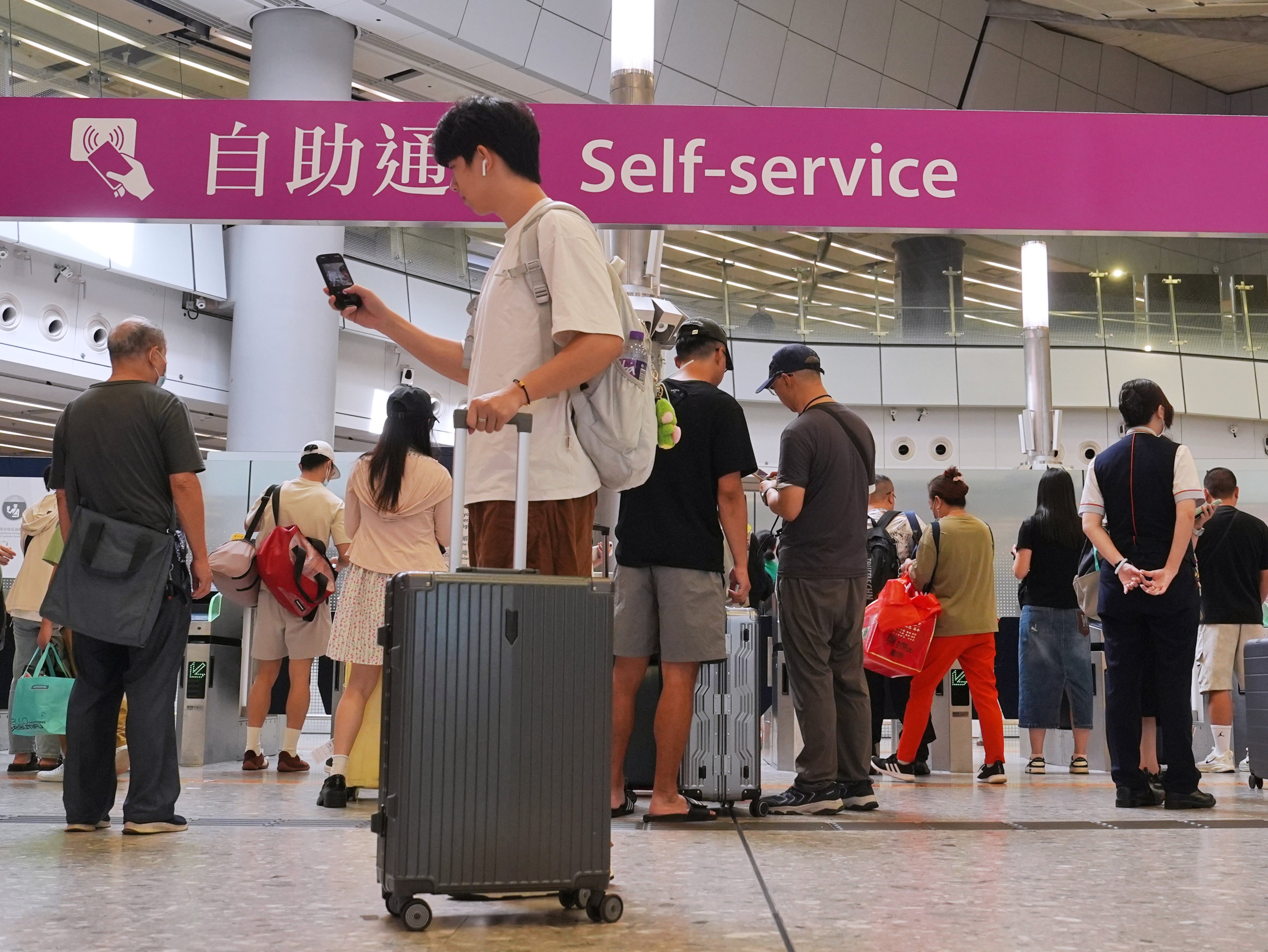 Travellers enter the gates at the departure hall of West Kowloon rail station. Photo: Elson Li