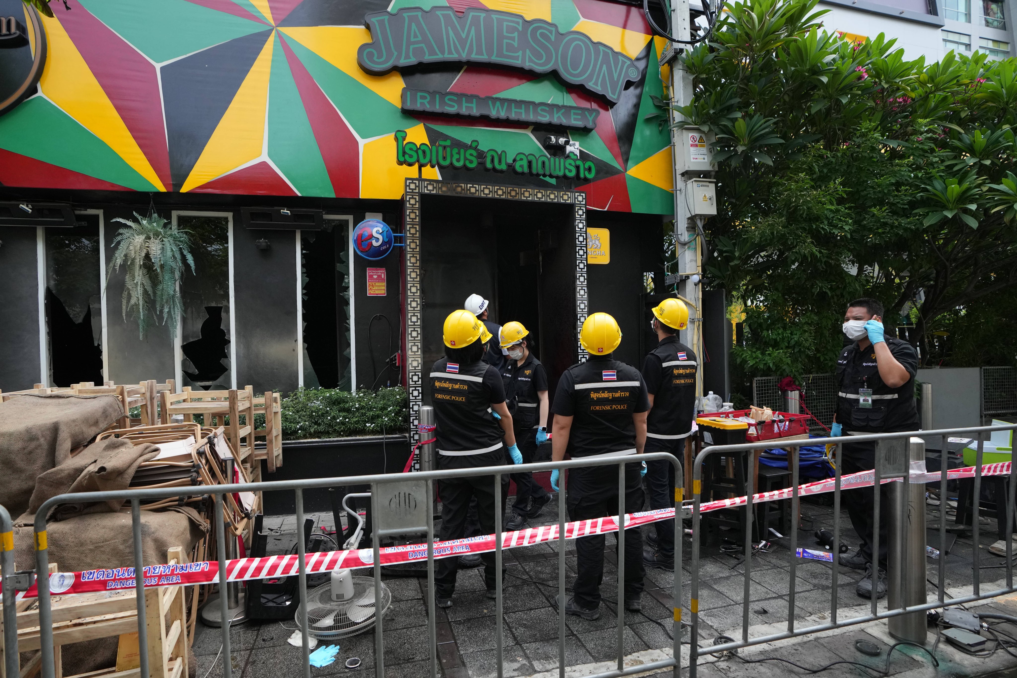 Forensic police officers inspect the site of the fire in Bangkok, Thailand. Photo: AP