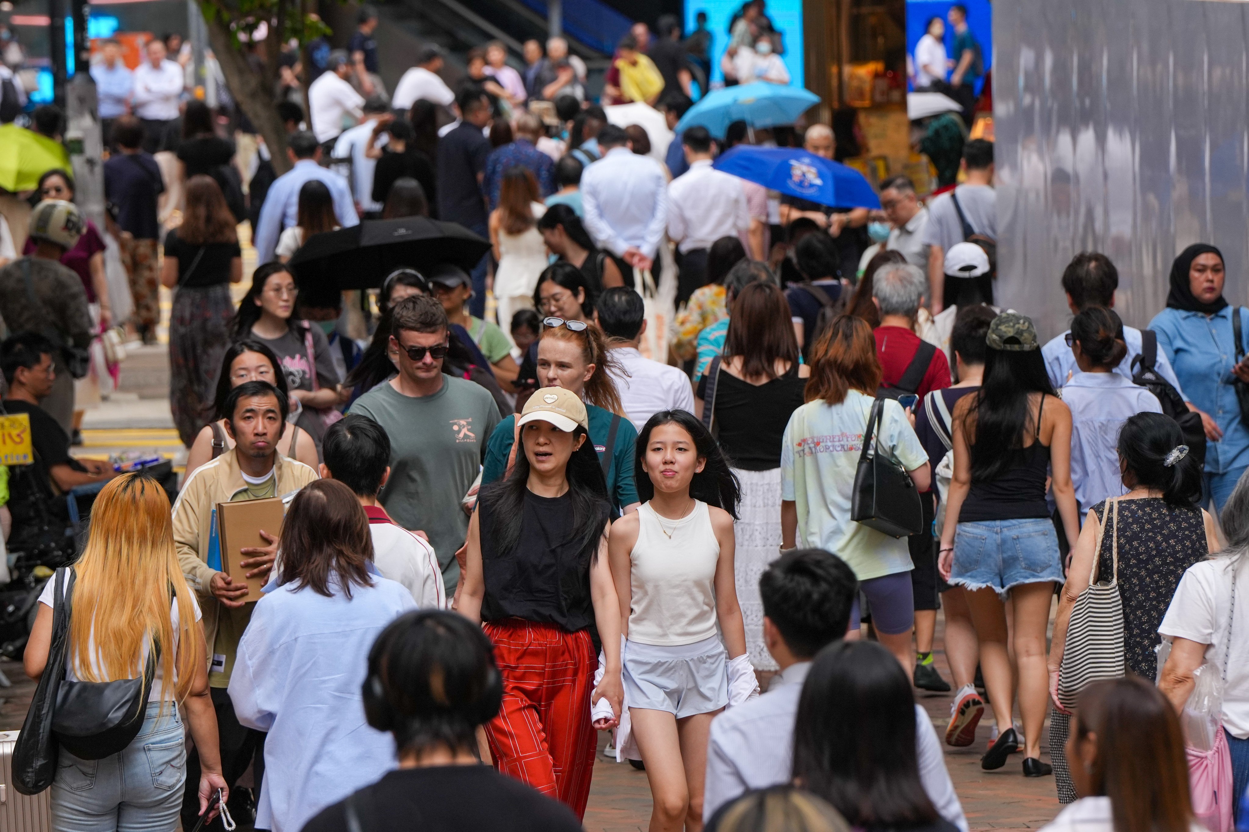 Pedestrians in Causeway Bay. The pilot scheme encourages CSSA recipients with the capacity to work to achieve self-reliance through sustained employment. Photo: Sam Tsang