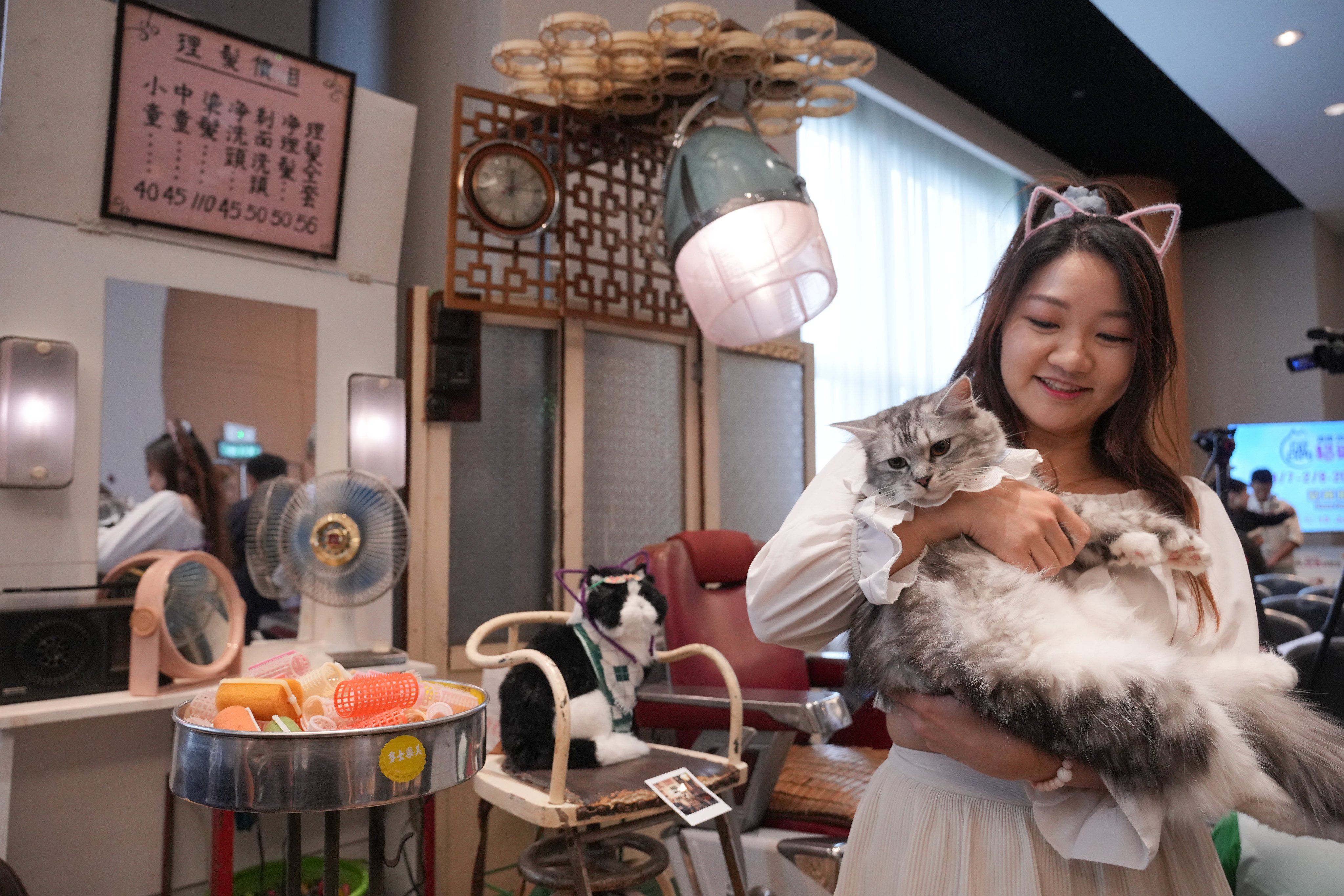 An expo participant, Moonna Tam, and her cat, Mia. Photo: May Tse