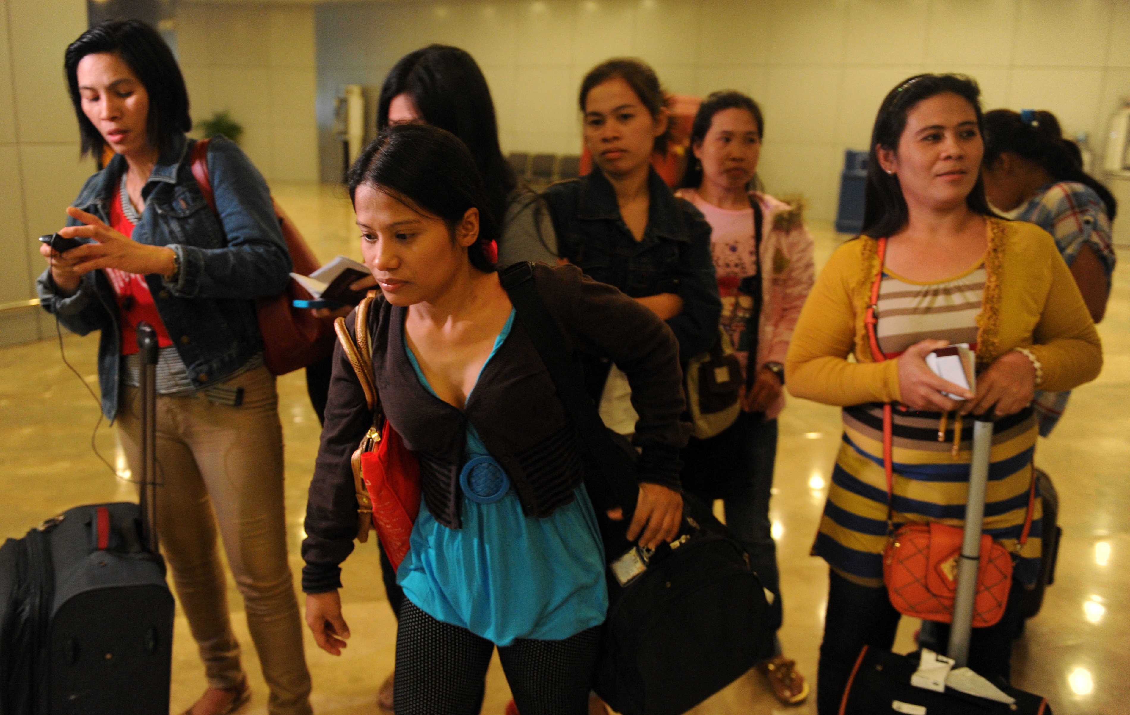Repatriated Filipino workers arrive in Manila from Saudi Arabia following a crackdown on undocumented workers by Riyadh in 2013. Photo: AFP