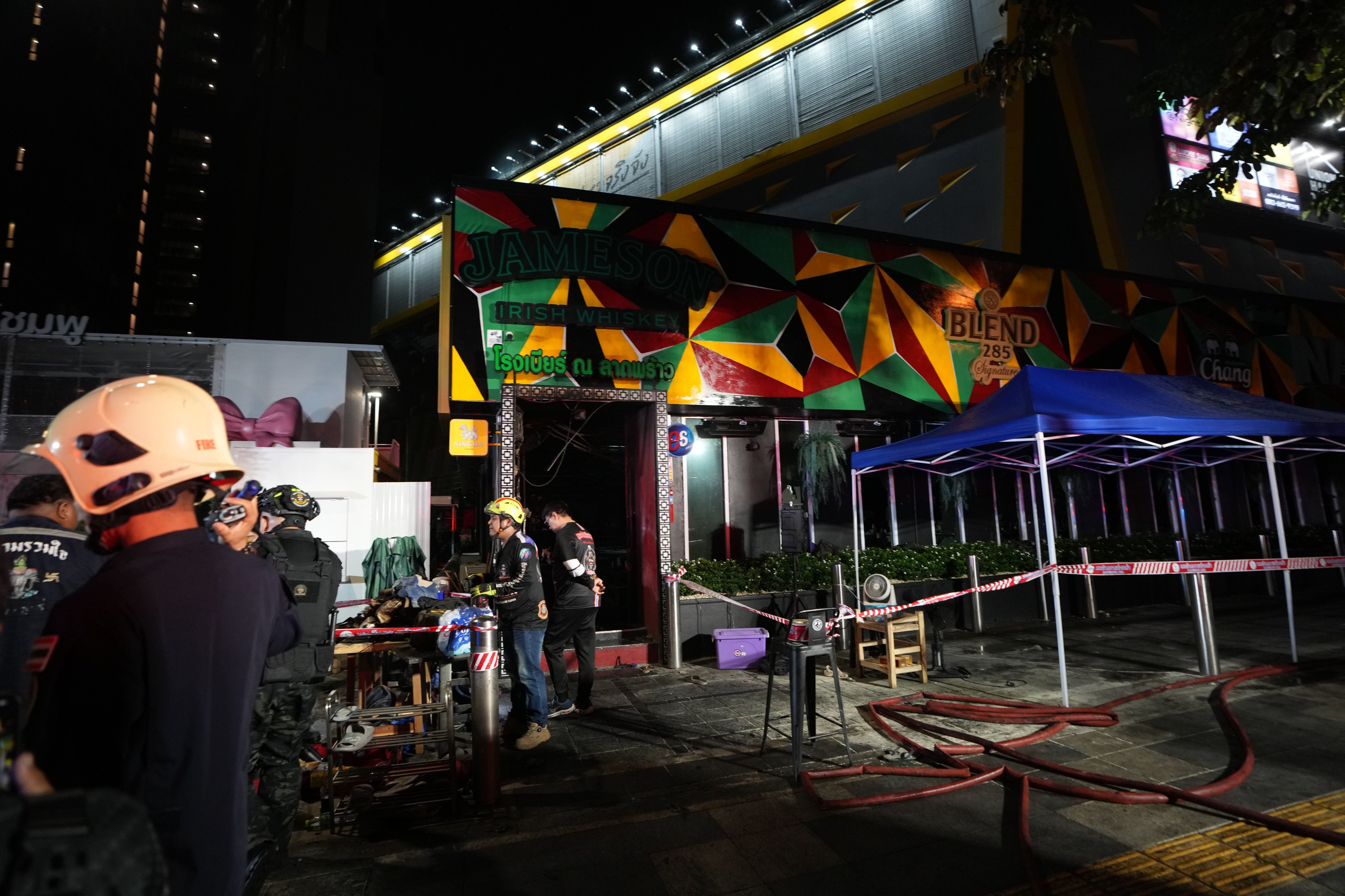 Rescuers work at the site of a fire in Bangkok, Thailand early on Monday. Photo: AP