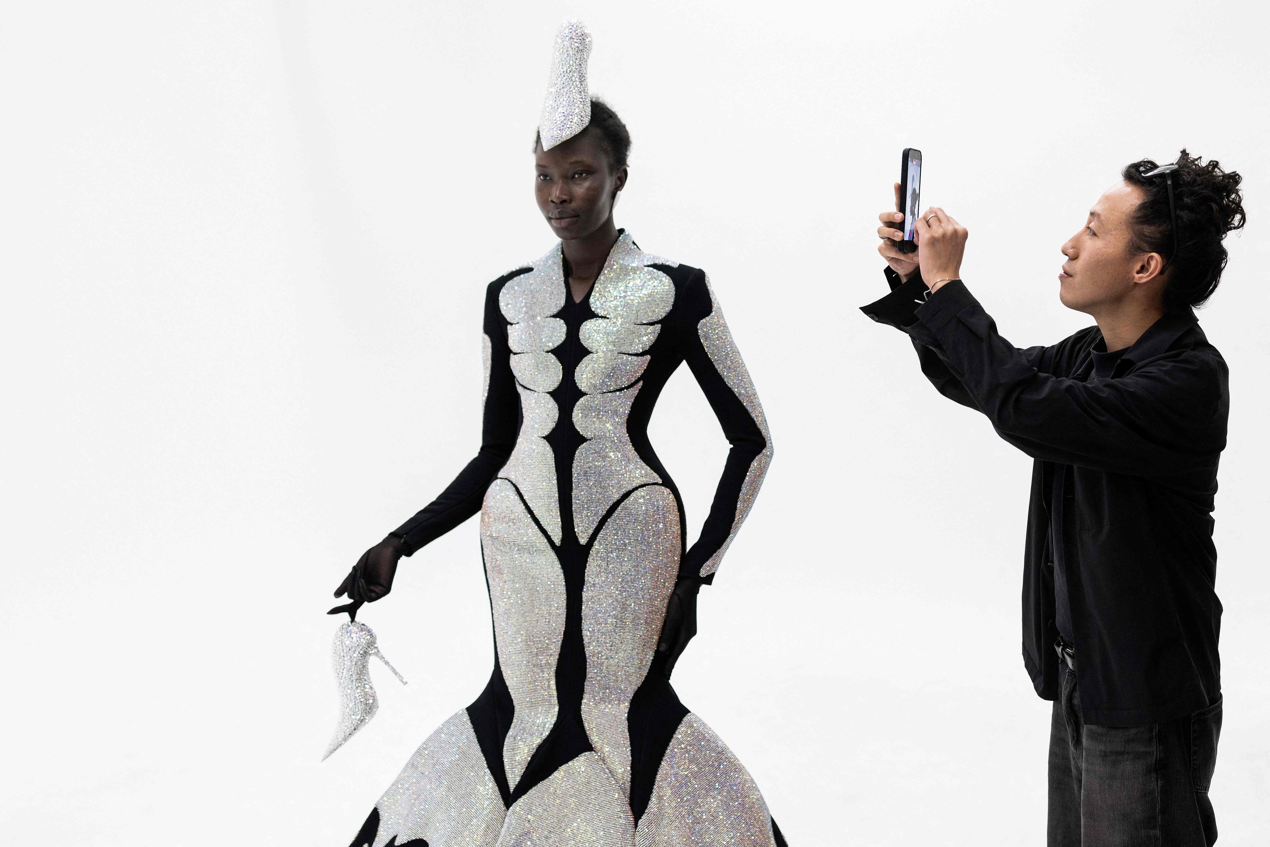 Hong Kong-born and London-based fashion designer Robert Wun with a model wearing one of his creations in Paris on July 7, 2026. Photo: AFP