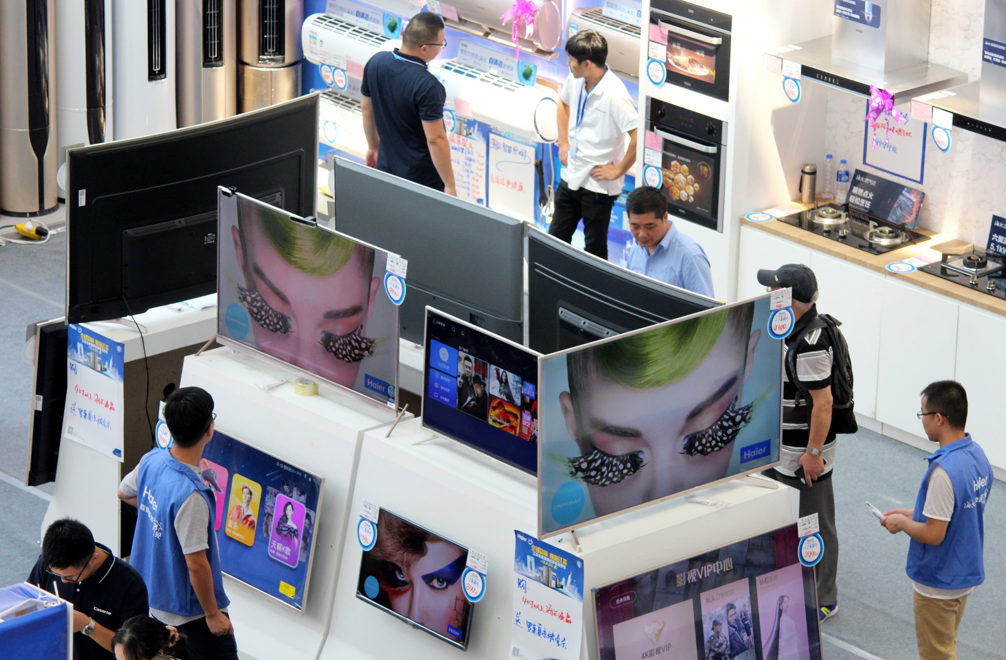 Customers check out televisions at a home appliances store in Changzhou, Jiangsu province. Photo: VCG
