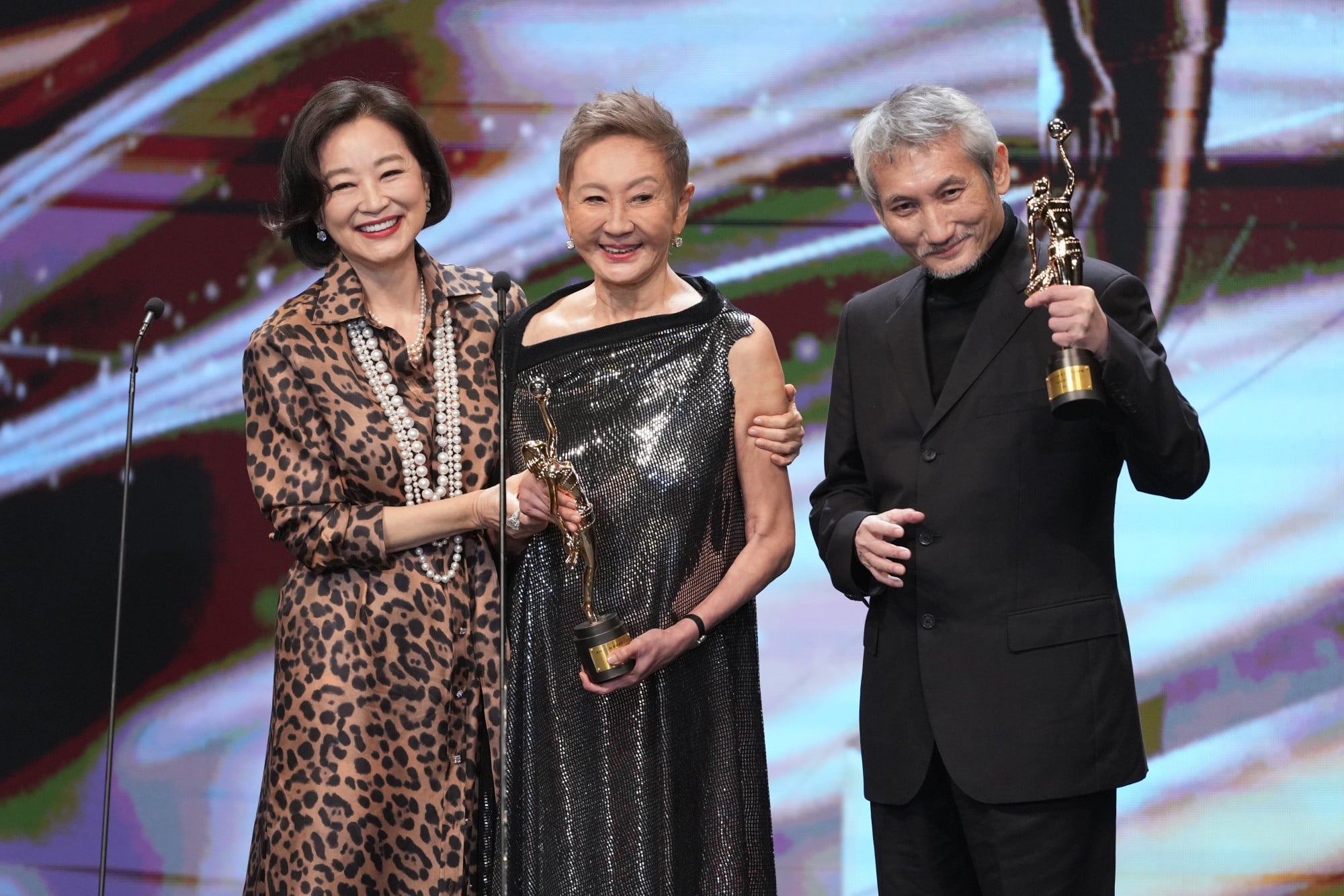 Actress Brigitte Lin (left) presents a lifetime achievement award to her best friend of many years, Shi, and the film producer’s former husband, Tsui Hark, at the 43rd Hong Kong Film Awards Ceremony. Photo: Eugene Lee Actress Brigitte Lin (left) presents a lifetime achievement award to her best friend of many years, Shi, and the film producer’s former husband, Tsui Hark, at the 43rd Hong Kong Film Awards Ceremony. Photo: Eugene Lee