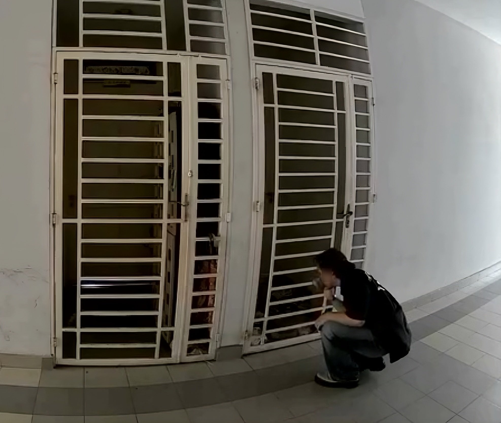 The viral video shows a man in a black T-shirt loitering in a corridor outside what is believed to be the victim’s home in Shah Alam, before reaching through a grille to grab her footwear and sniff it. Photo: Threads